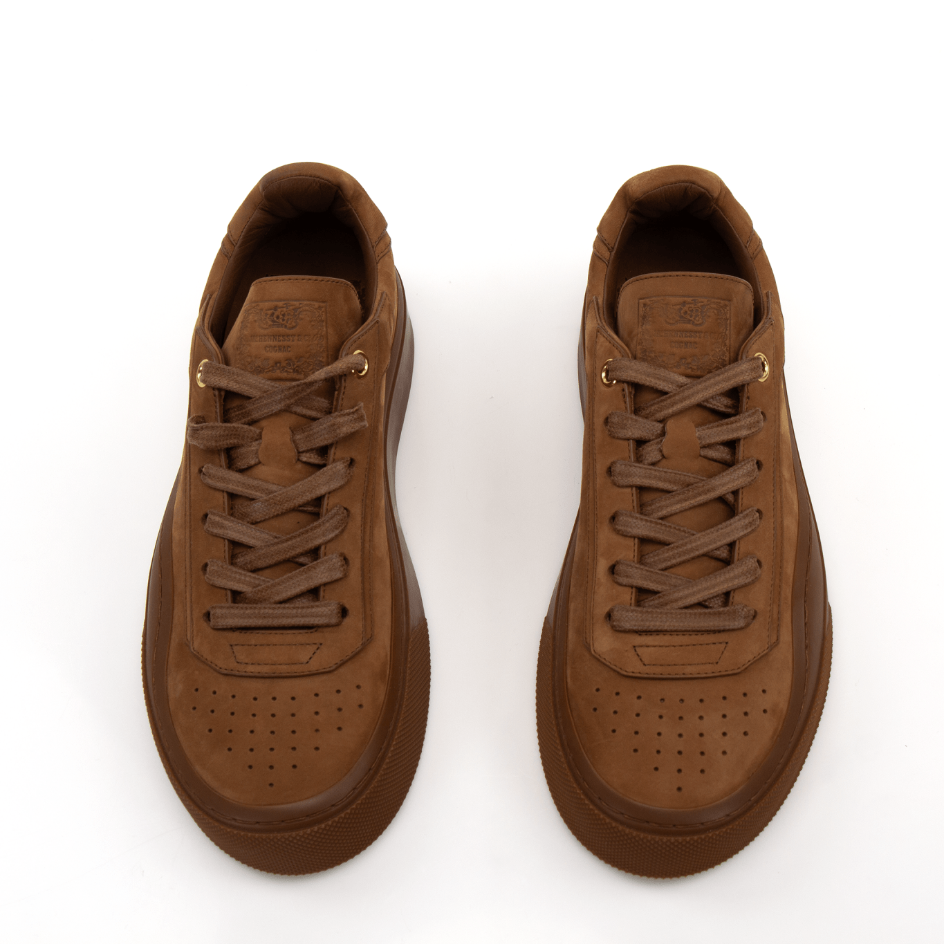 Gold &amp; Beyond Hennessy Hammocks x Kim Jones sneakers showing sleek black shoes with stylish design and branding details.