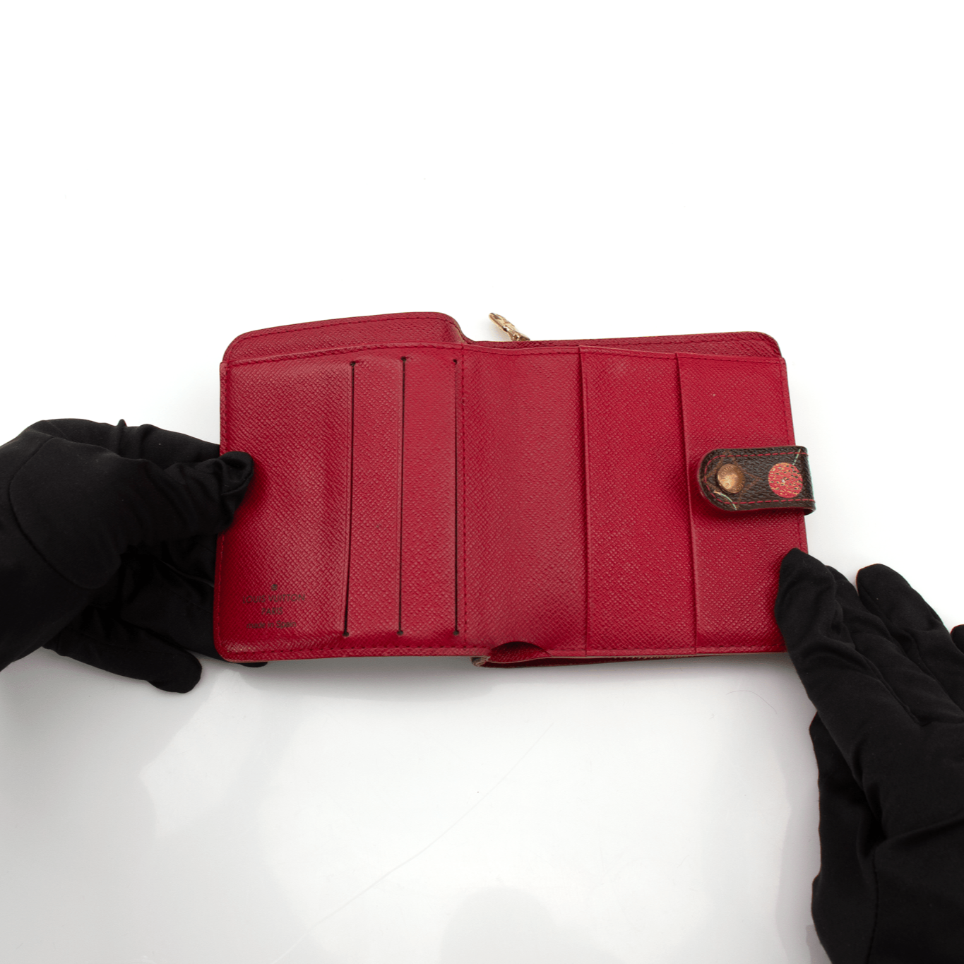 Louis Vuitton Cherry Cerise Zippy Wallet with zip-around closure and Louis Vuitton logo on the front, featuring vibrant red and pink tones.