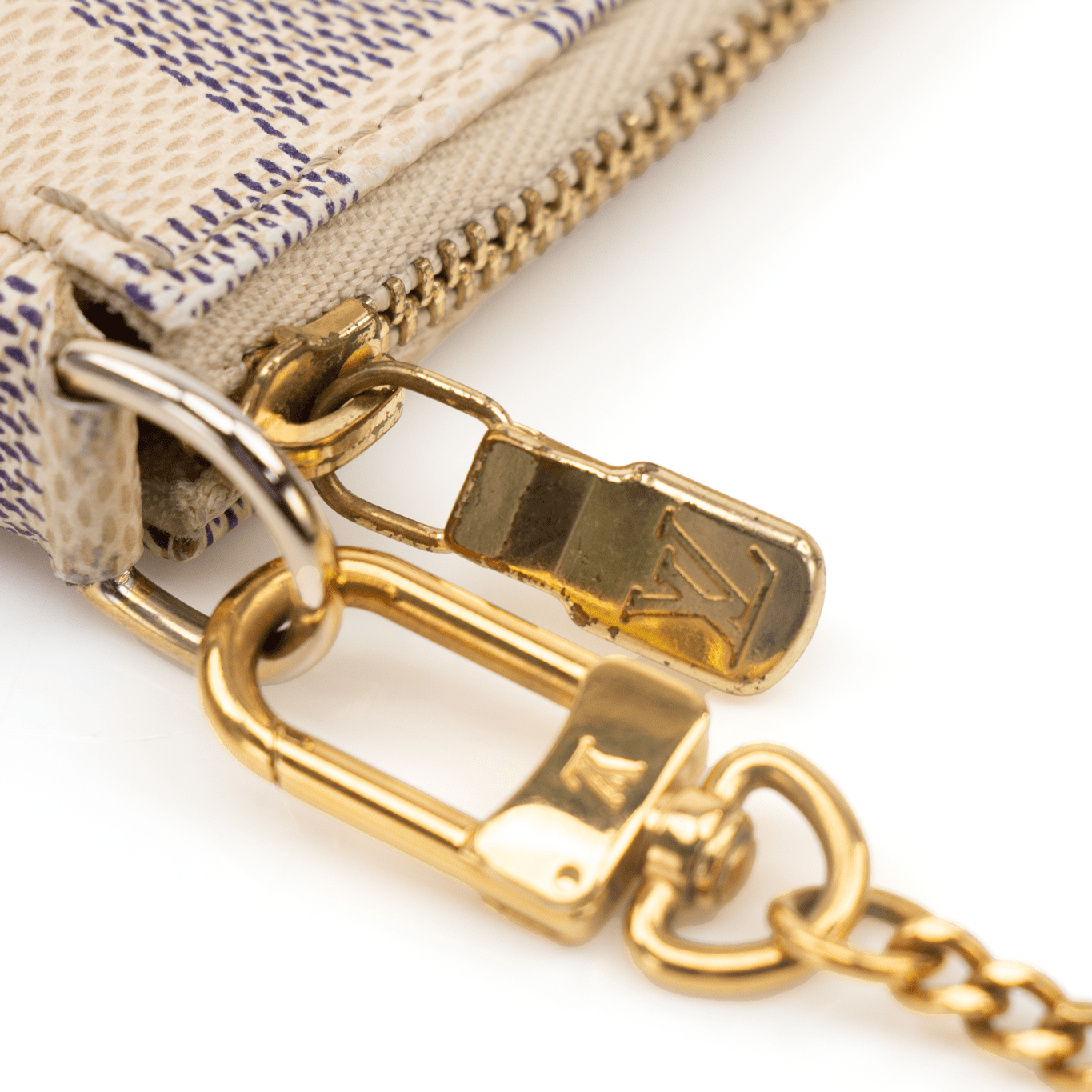 Louis Vuitton Mini Pochette wallet in a stylish design, showcasing the brand's signature monogram and compact size.