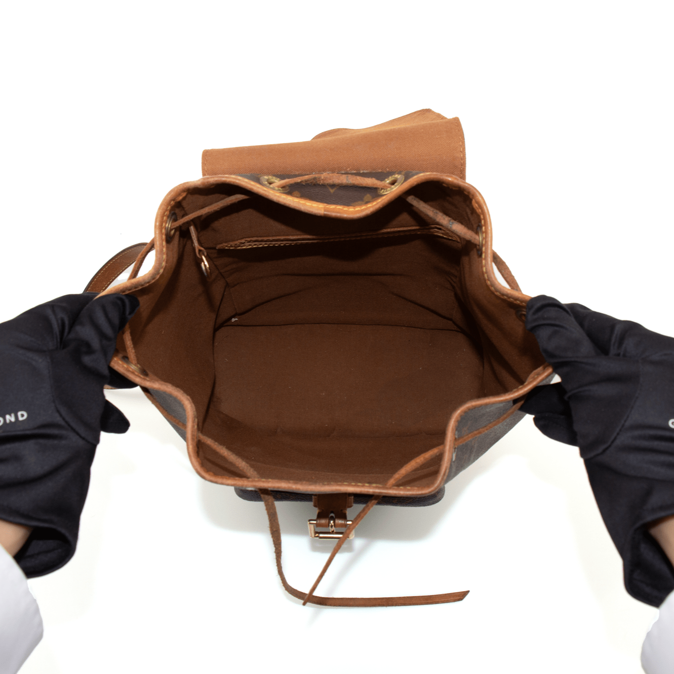 Gold & Beyond Louis Vuitton Montsouris backpack for travel, featuring brown monogram pattern, adjustable straps, and front zip pocket.