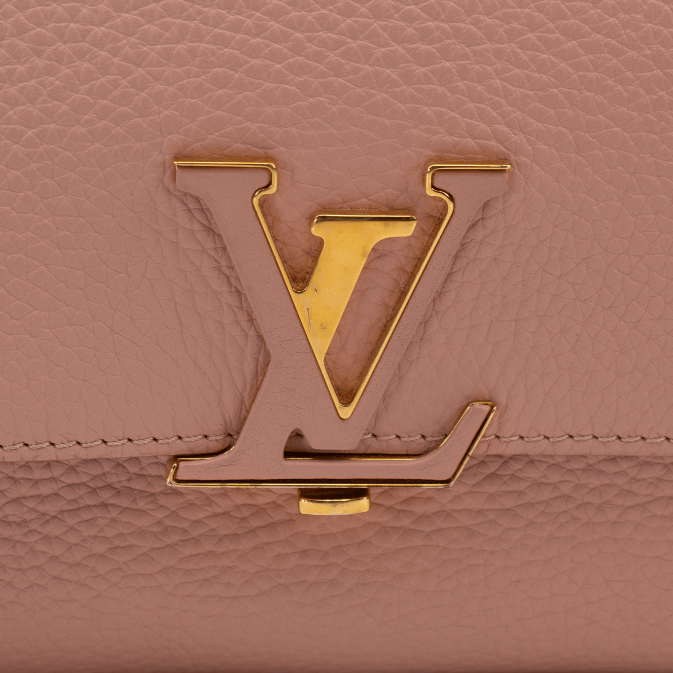 Louis Vuitton Volta handbag featuring a sleek design and gold accents on a neutral background.