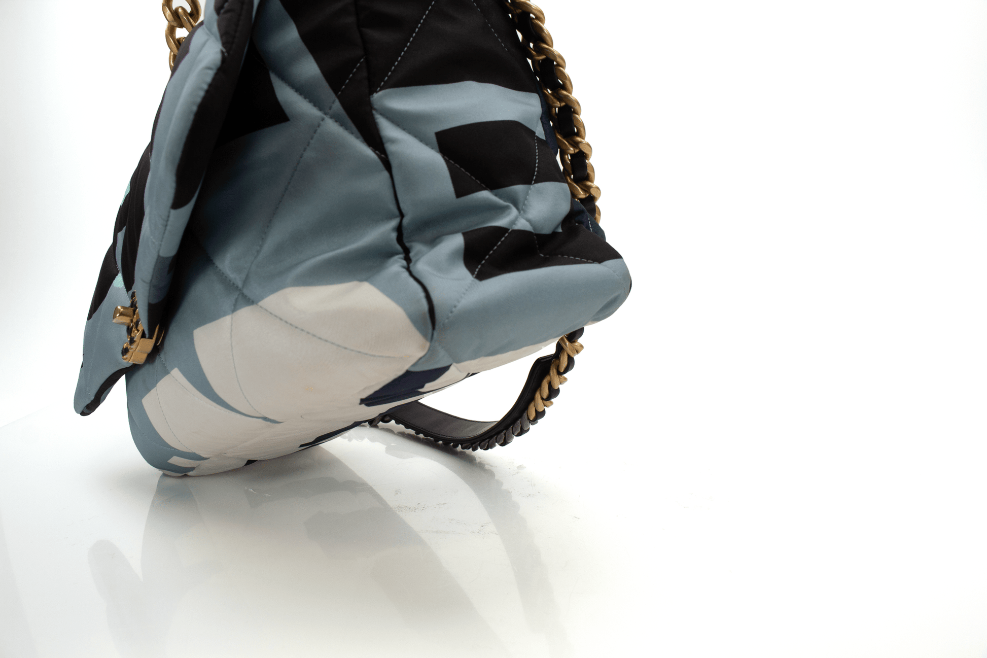 Chanel 19 silk flap handbag in elegant design, featuring a soft texture and classic gold hardware accents.