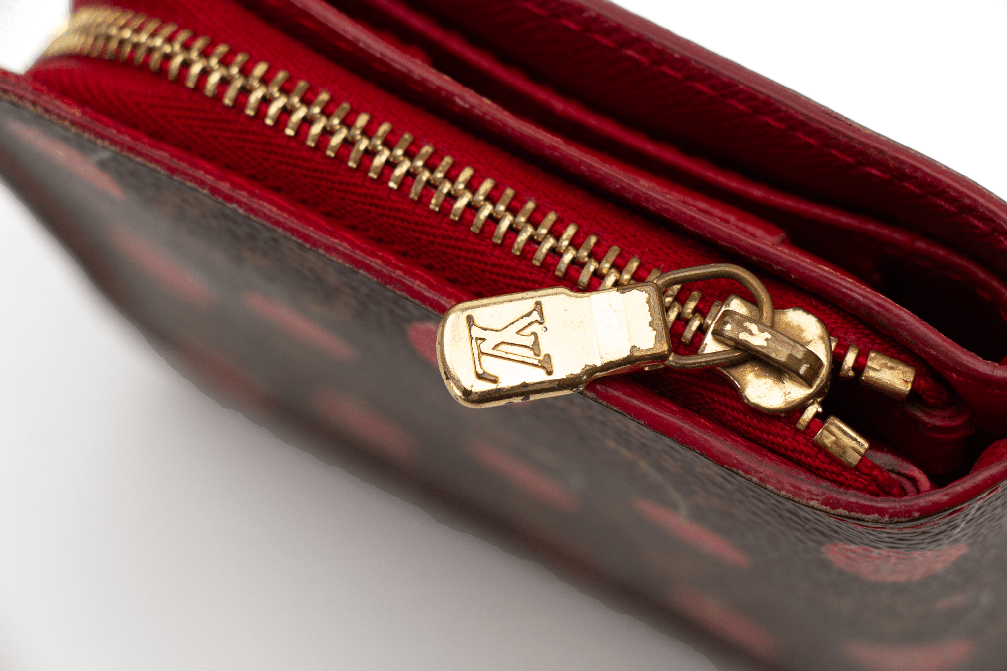 Louis Vuitton Cherry Cerise Zippy Wallet with leather exterior, gold-tone zipper, and branded logo details.