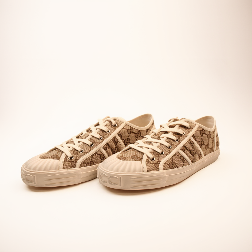 Gold & Beyond Gucci GG Supreme sneakers, stylish shoes with iconic monogram pattern, white soles, and modern design.