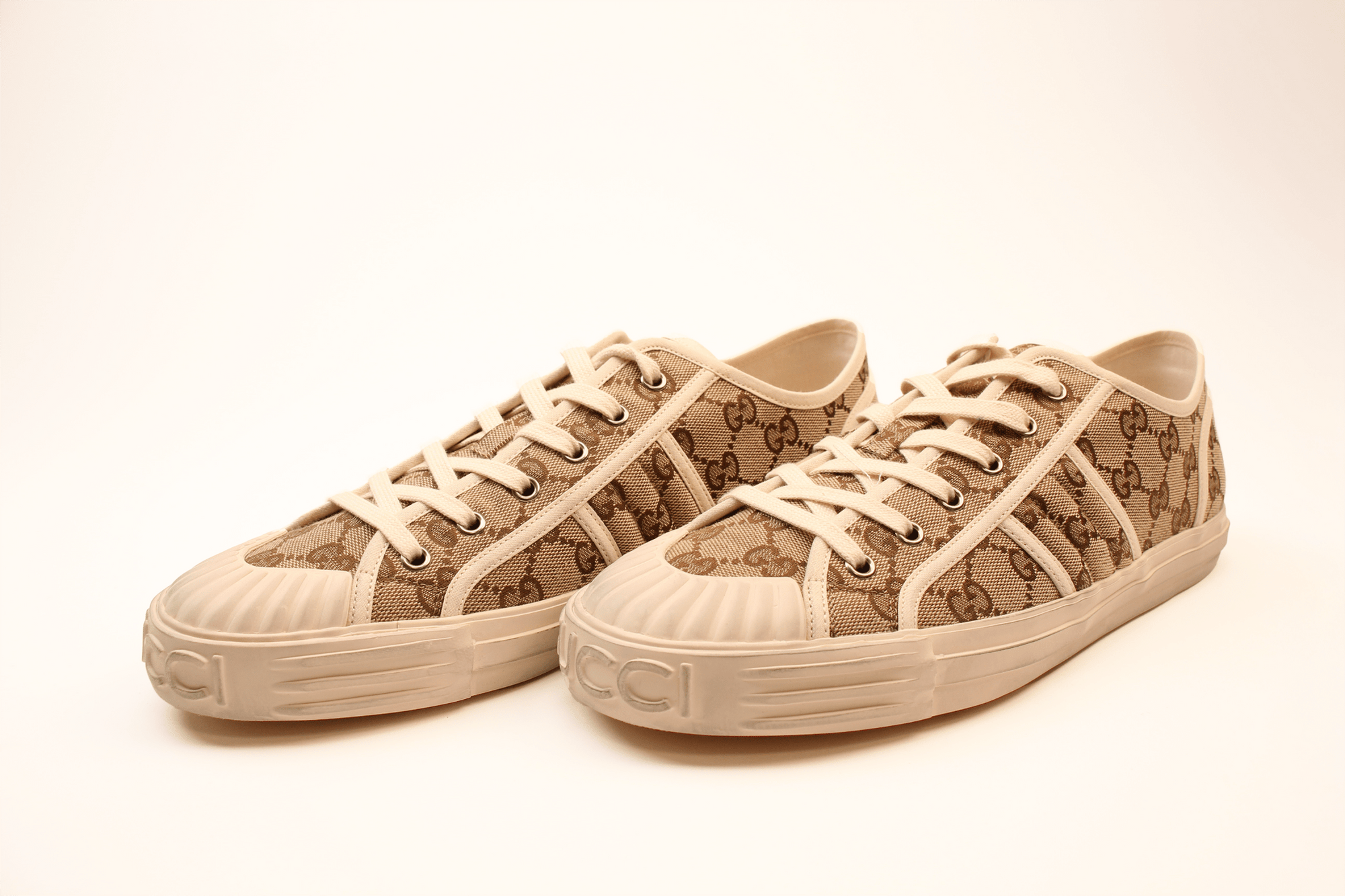 Gold & Beyond Gucci GG Supreme sneakers, stylish shoes with signature monogram pattern and comfortable design.