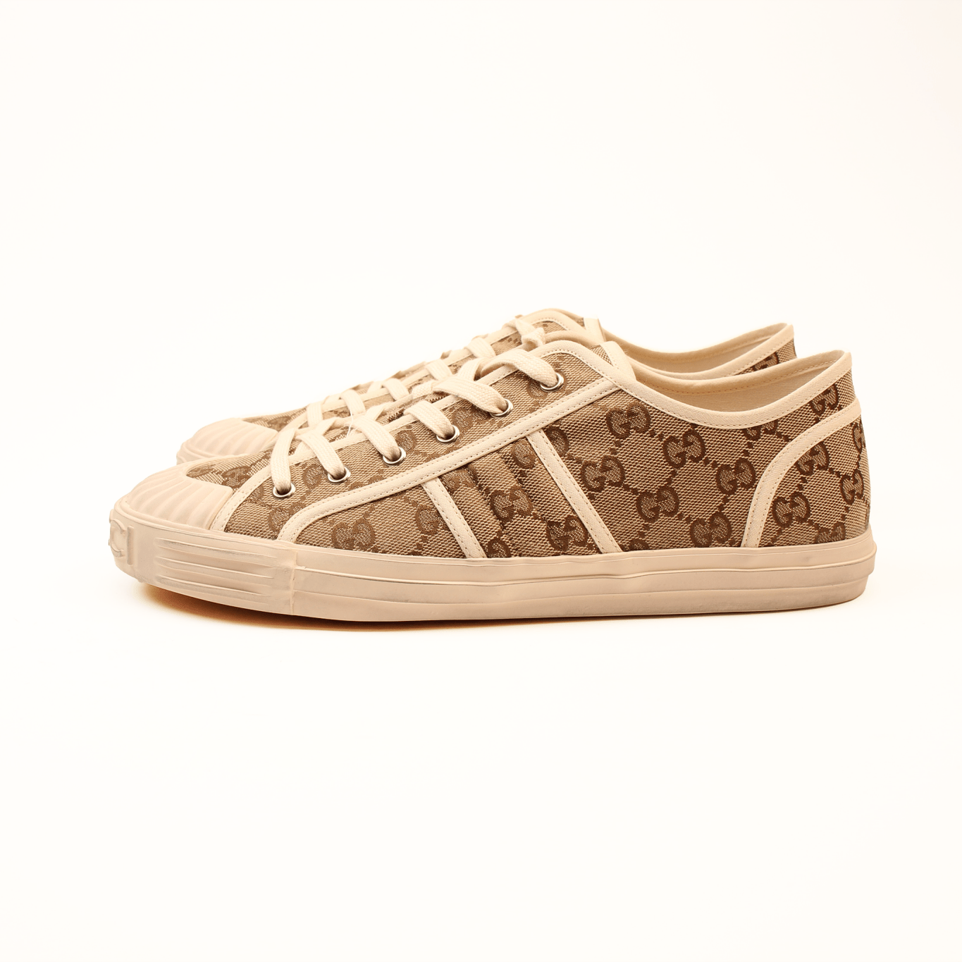 Gold & Beyond Gucci GG Supreme sneakers, stylish shoes with iconic monogram pattern and white rubber soles.