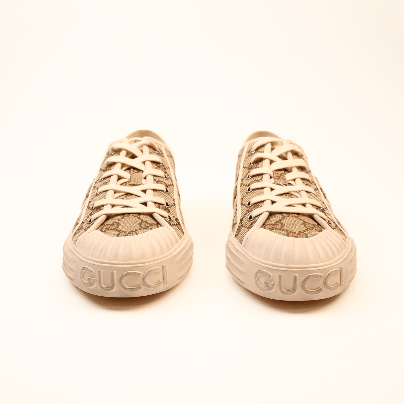 Gold & Beyond Gucci GG Supreme Sneakers, stylish shoes with iconic pattern, white soles, and comfortable design.