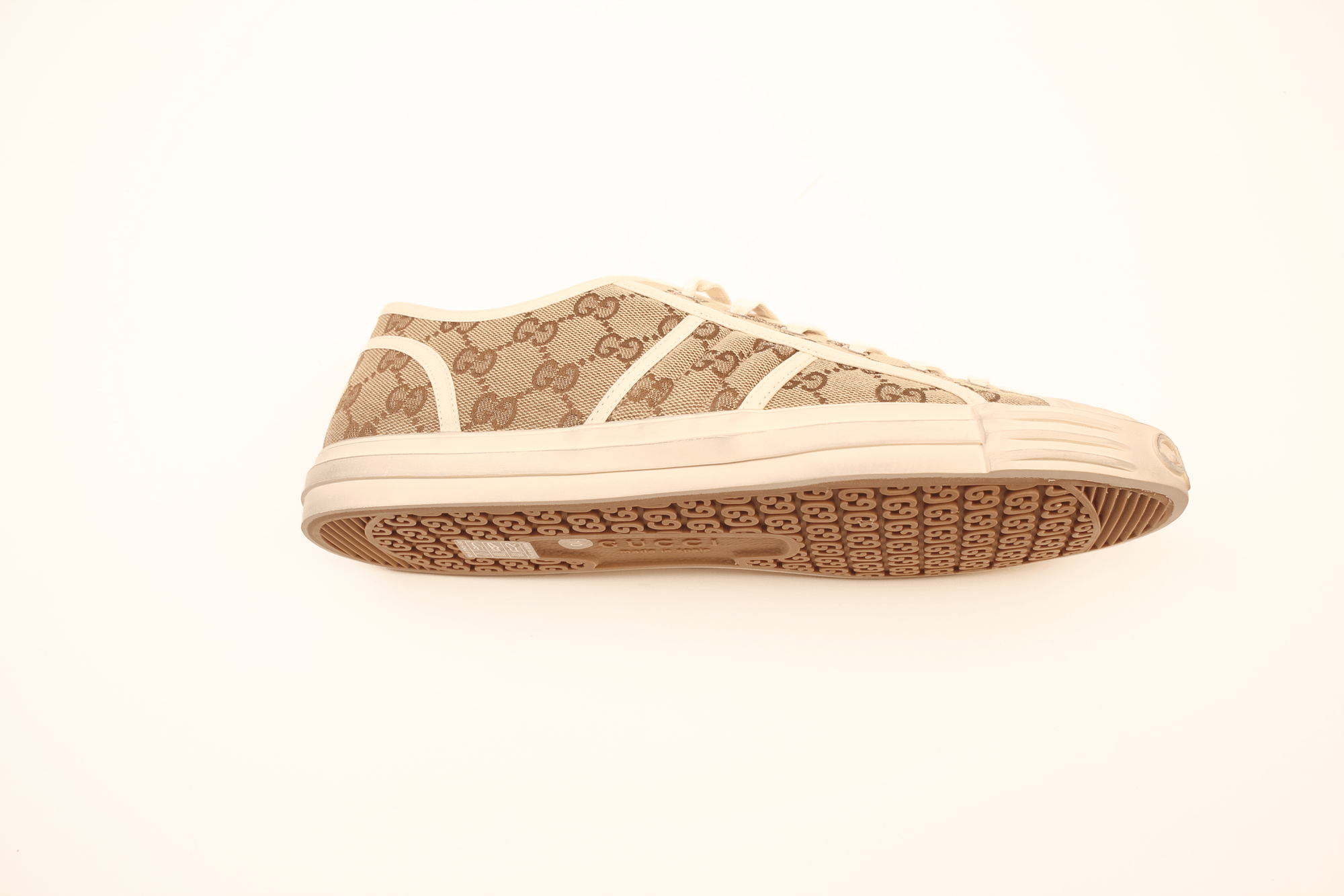 Gold & Beyond Gucci GG Supreme sneakers, stylish shoes with signature monogram pattern and white rubber soles.