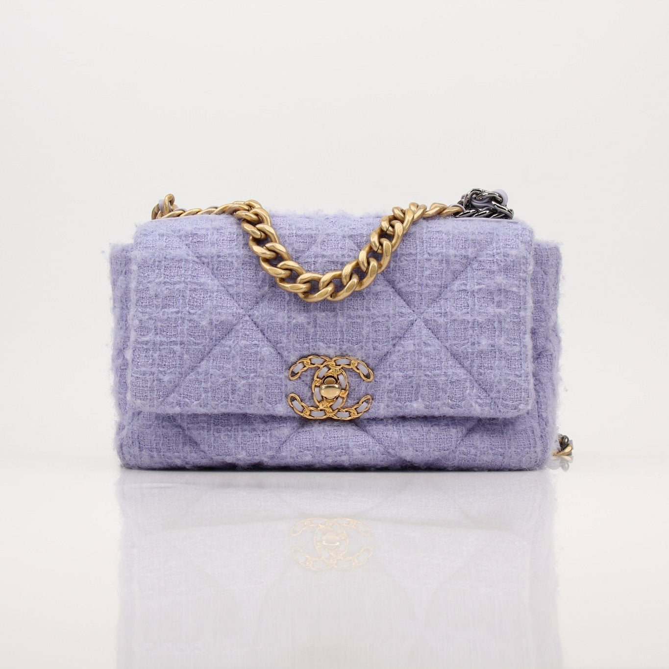 Gold & Beyond Chanel 19 Flap Bag handbag with quilted leather and gold-tone hardware, featuring a classic flap closure.