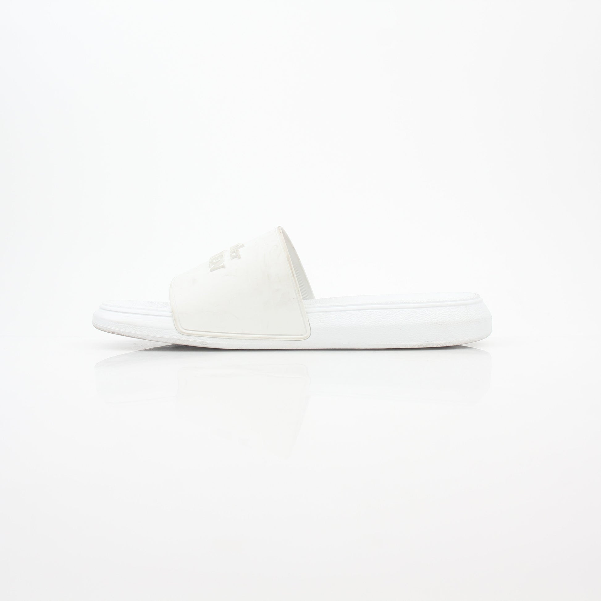 White Alexander McQueen logo pool slide sandals with open-toe design and slip-on style, displayed on a neutral background.
