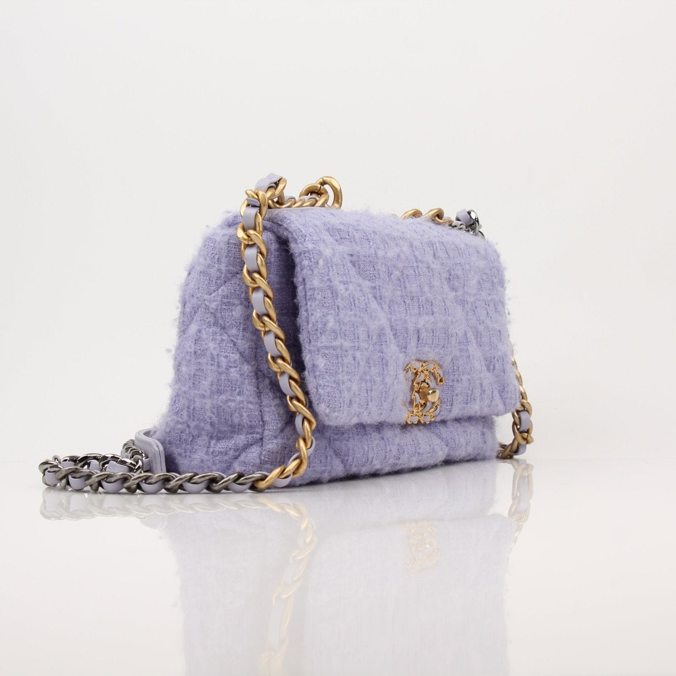 Gold & Beyond Chanel 19 Flap Handbag with quilted leather and gold-tone hardware, featuring the iconic Chanel logo.