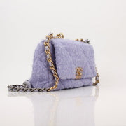 Gold & Beyond Chanel 19 Flap Handbag with quilted leather and gold-tone hardware, featuring the iconic Chanel logo.