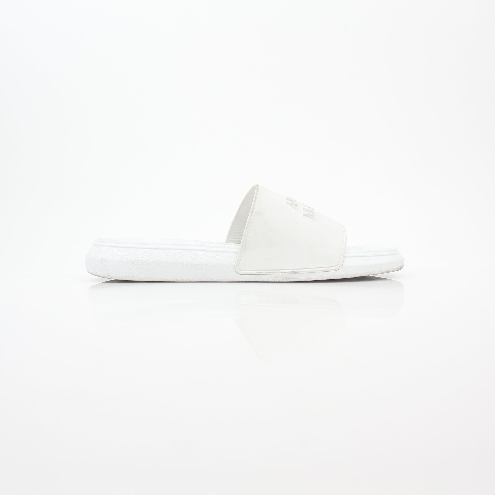 Alexander McQueen white logo pool slide sandals with open-toe design and branded strap, displayed on a neutral background