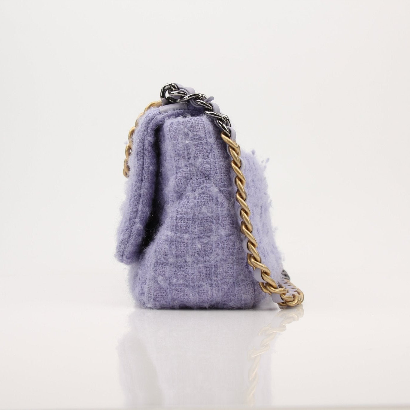 Gold & Beyond Chanel 19 Flap Handbag showing quilted leather exterior and classic chain strap on a plain background.