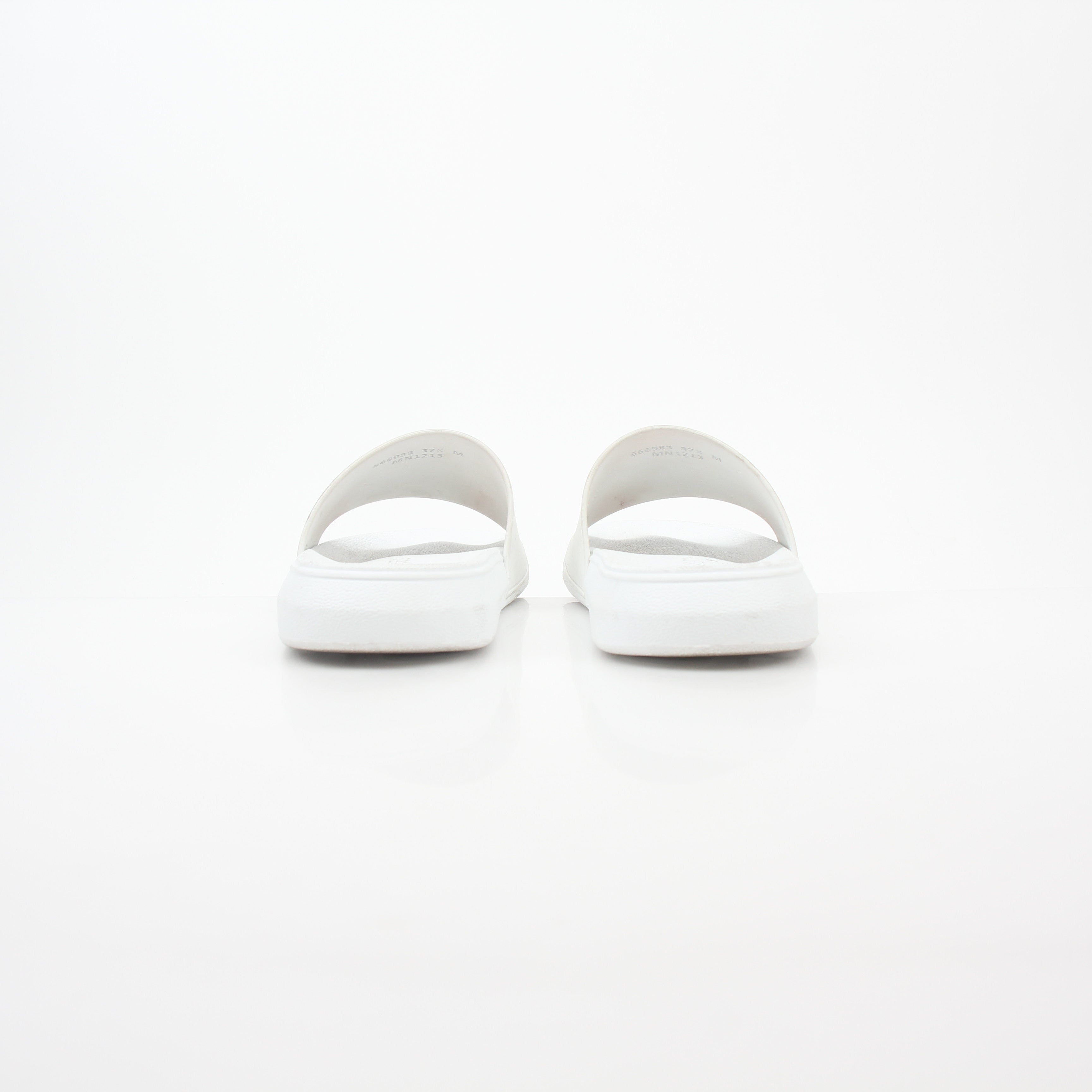 White Alexander McQueen logo pool slide sandals with cushioned straps and slip-on design for comfortable summer wear.
