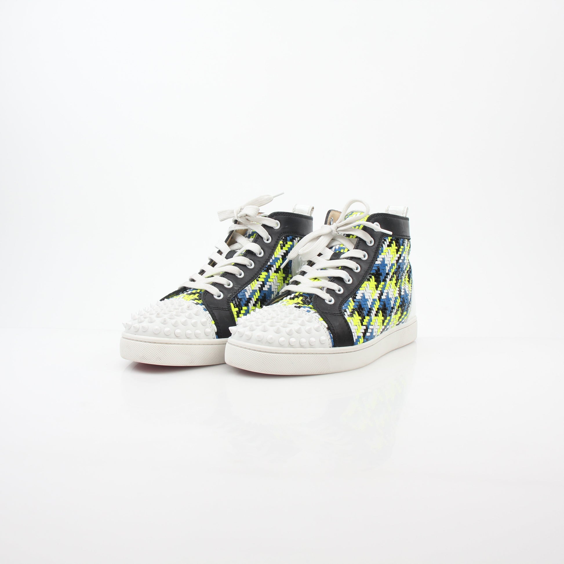 Close-up of Christian Louboutin Multicolor Louis Spikes high-top sneakers with spiked details, featuring vibrant colors and textured design.