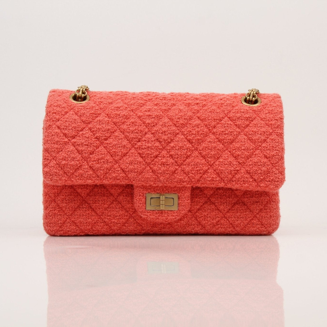 Gold & Beyond Chanel Tweed Re-Issue Flap Handbag with chain strap and classic quilted design, styled on a neutral background.
