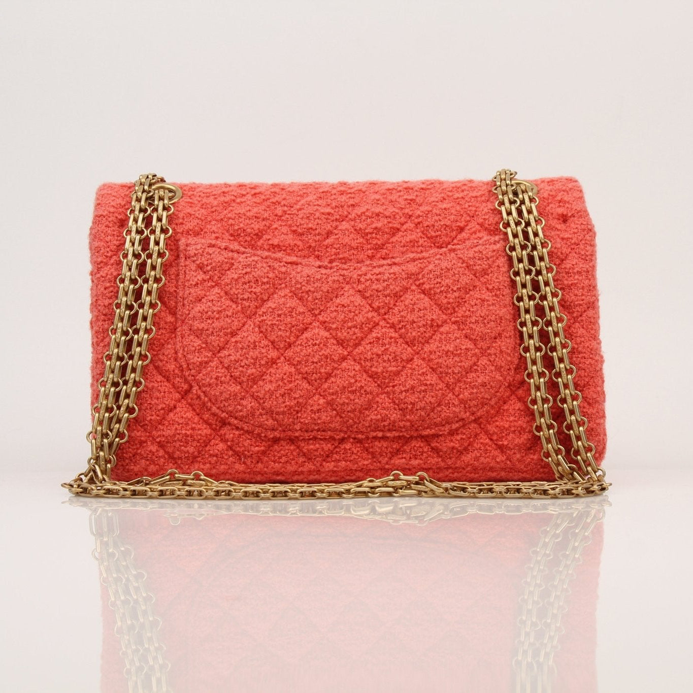 Gold & Beyond Chanel Tweed Re-Issue Flap Bag handbag with chain strap and classic tweed fabric, detailed close-up shot.