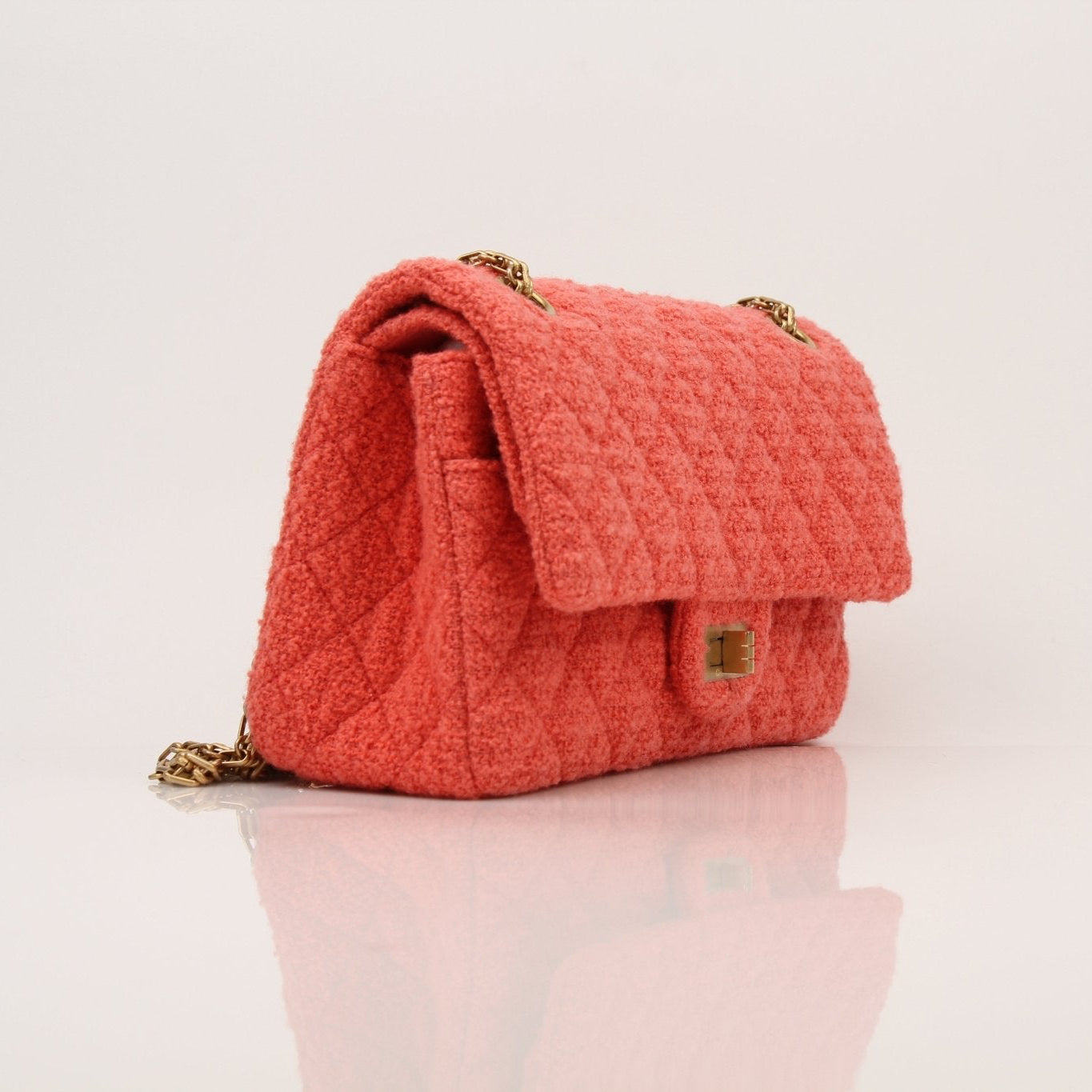 Gold & Beyond Chanel Tweed Re-Issue Flap Handbag with chain strap and classic quilted design, showcasing elegant luxury.