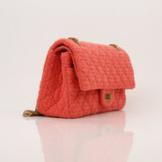 Gold & Beyond Chanel Tweed Re-Issue Flap Handbag with chain strap and classic quilted design, showcasing elegant luxury.