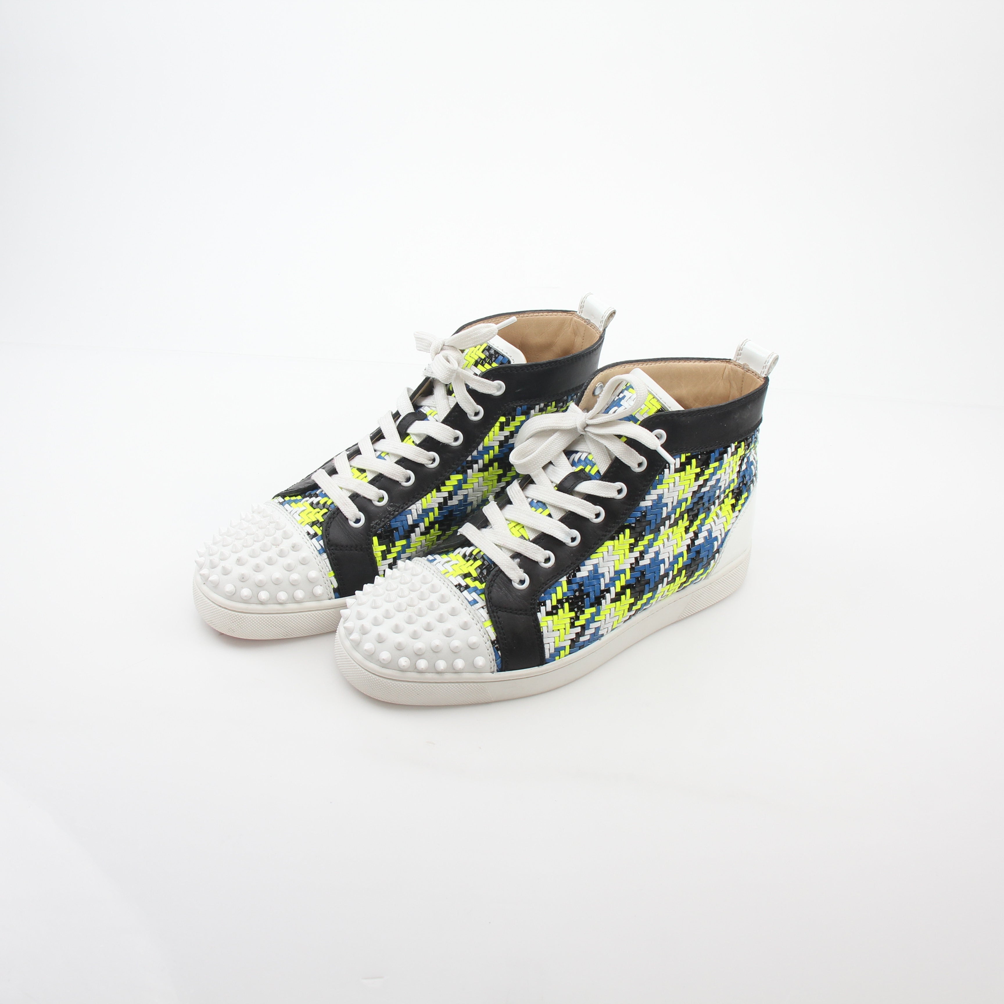 Close-up of Christian Louboutin Louis Spikes high-top sneakers with multicolor design and signature spike details, by Gold & Beyond.
