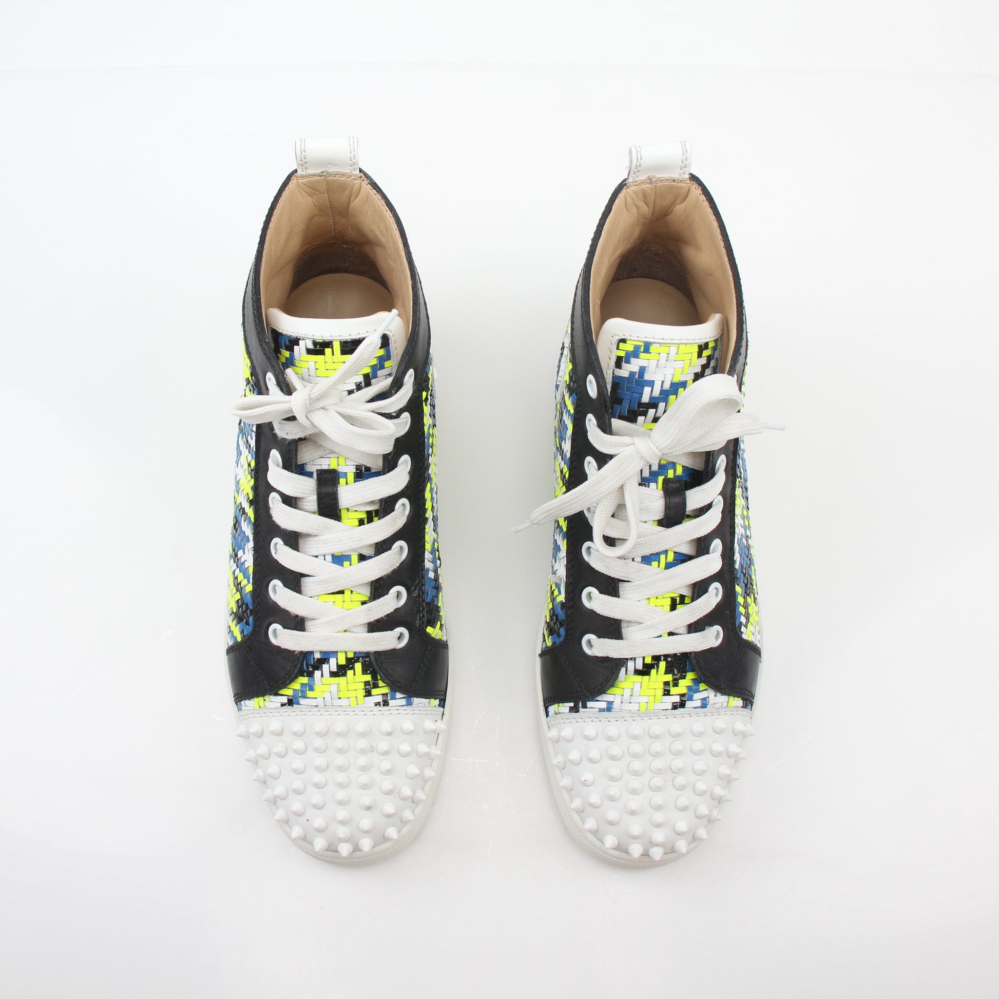 Close-up of Christian Louboutin Multicolor Louis Spikes high-top sneakers with spikes and vibrant design details.