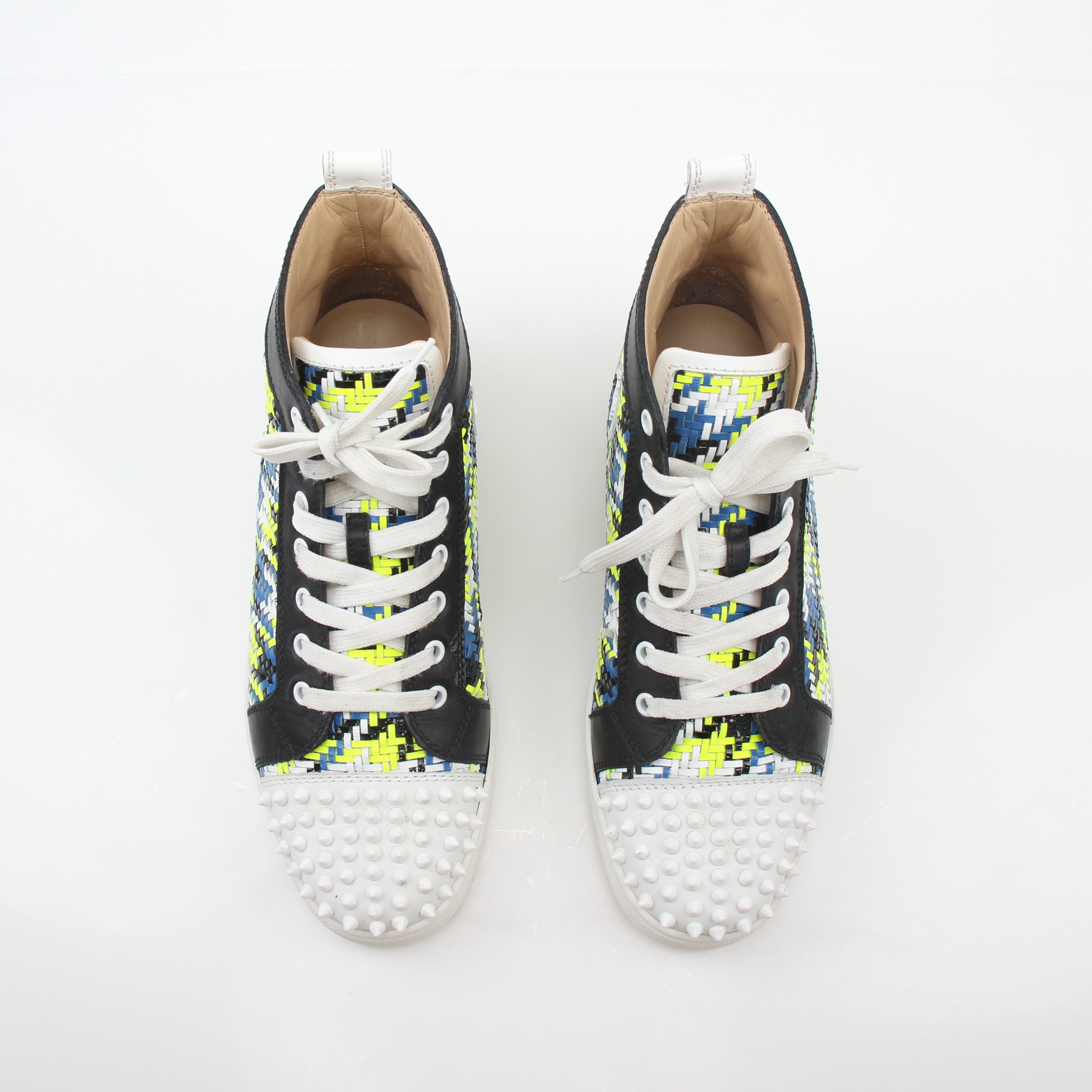 Close-up of Christian Louboutin Multicolor Louis Spikes high-top sneakers with spikes and vibrant design details.