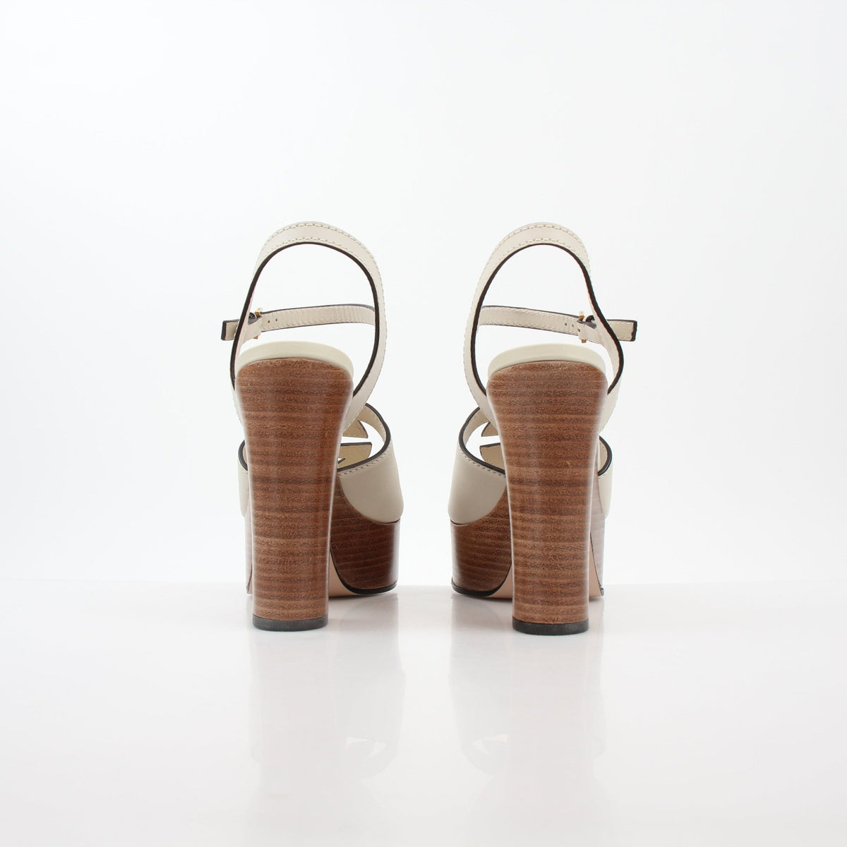 Gucci Ivory Interlocking G cutout platform heels with ankle straps and chunky soles, stylish women's designer sandals.
