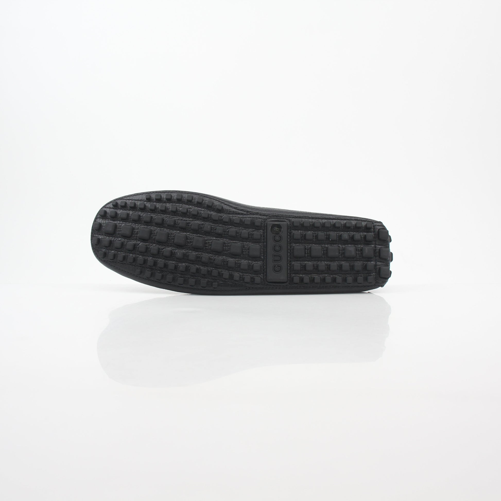 Gucci black leather Ayrton horsebit driving loafers, stylish men's shoes with gold accents, detailed stitching, and classic design.