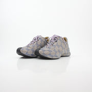 Gucci beige GG monogram Run sneakers with white soles and laces, showcasing the iconic pattern and stylish design.