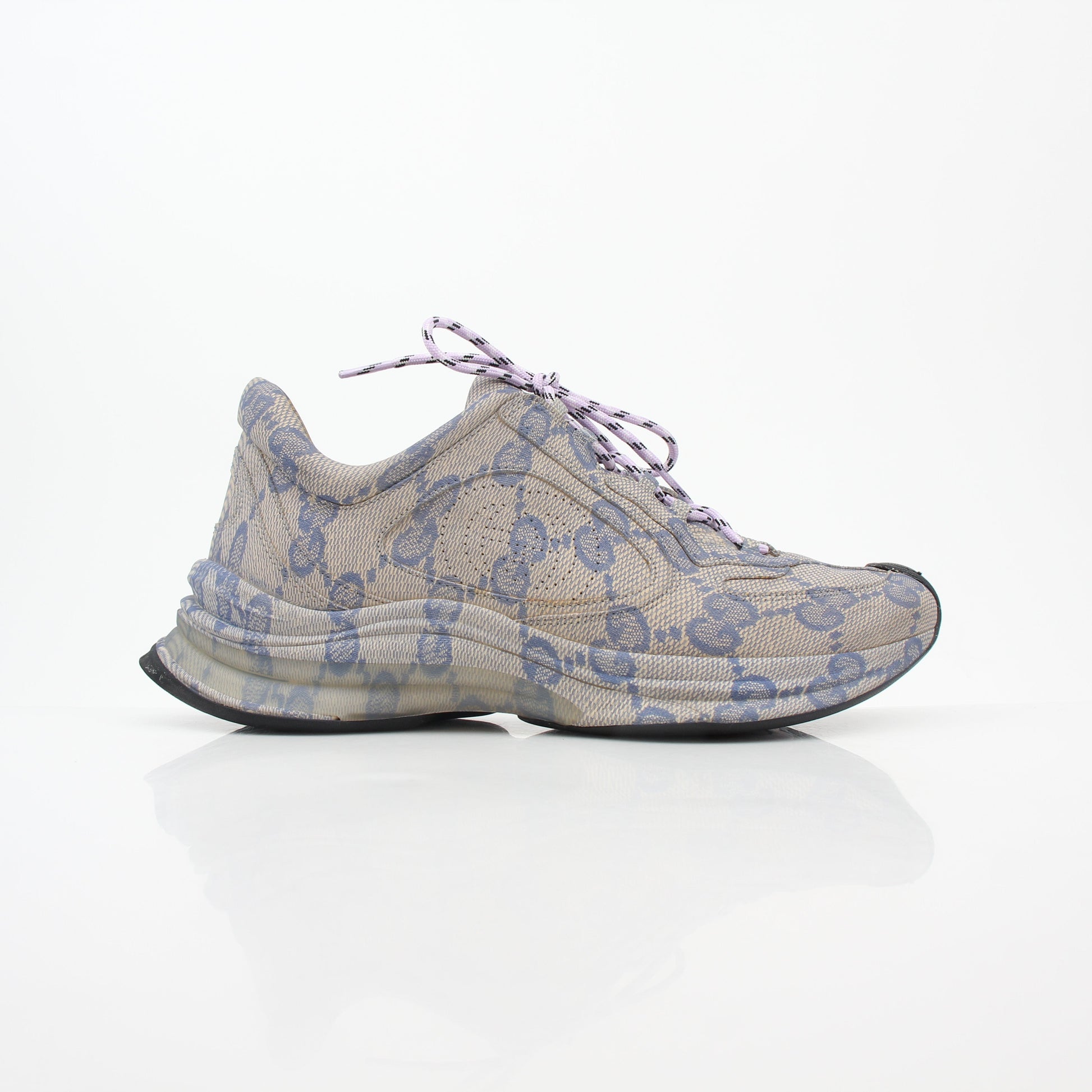 Gucci beige GG monogram Run sneakers with white soles and gold accents, stylish footwear for casual wear.