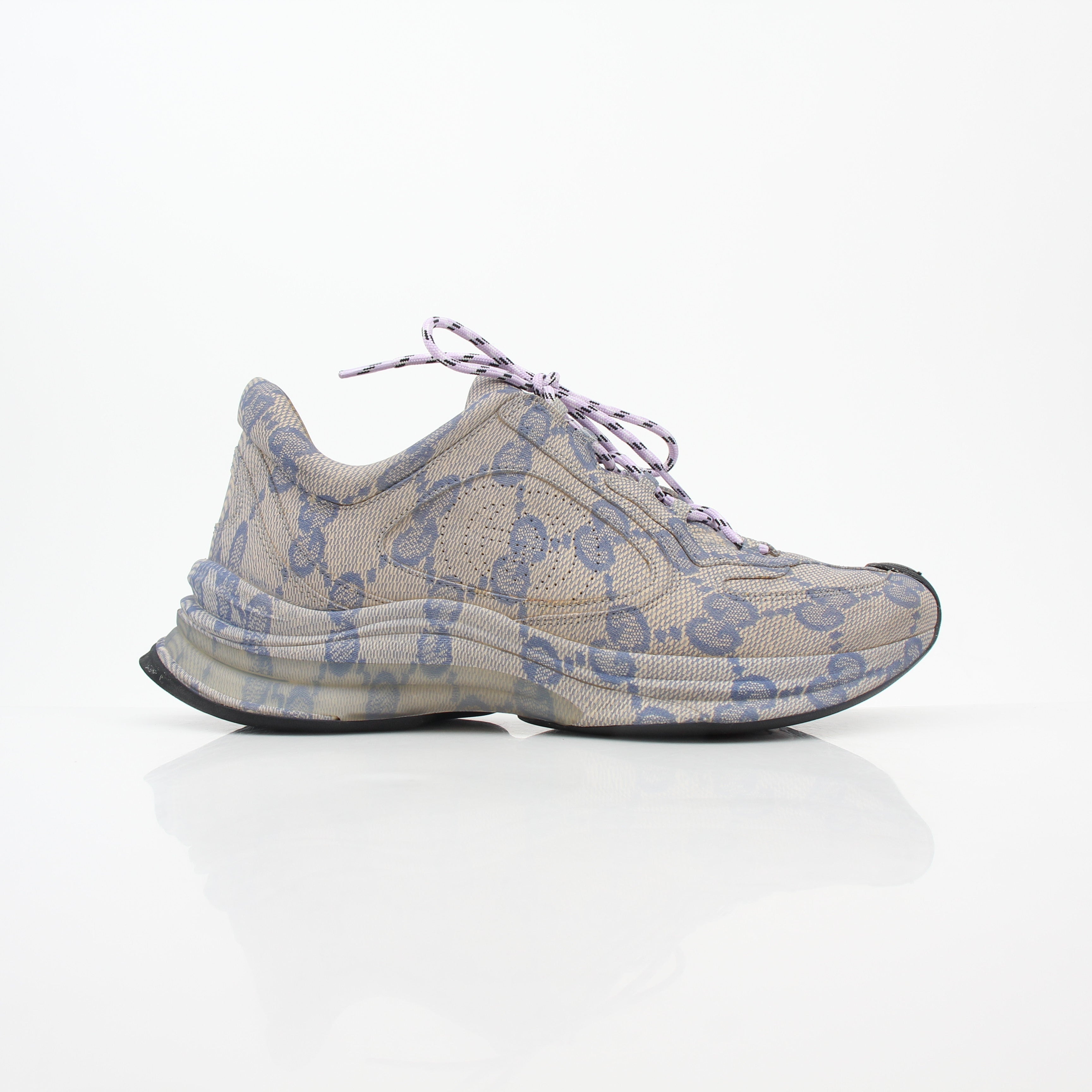 Gucci beige GG monogram Run sneakers with white soles and gold accents, stylish footwear for casual wear.
