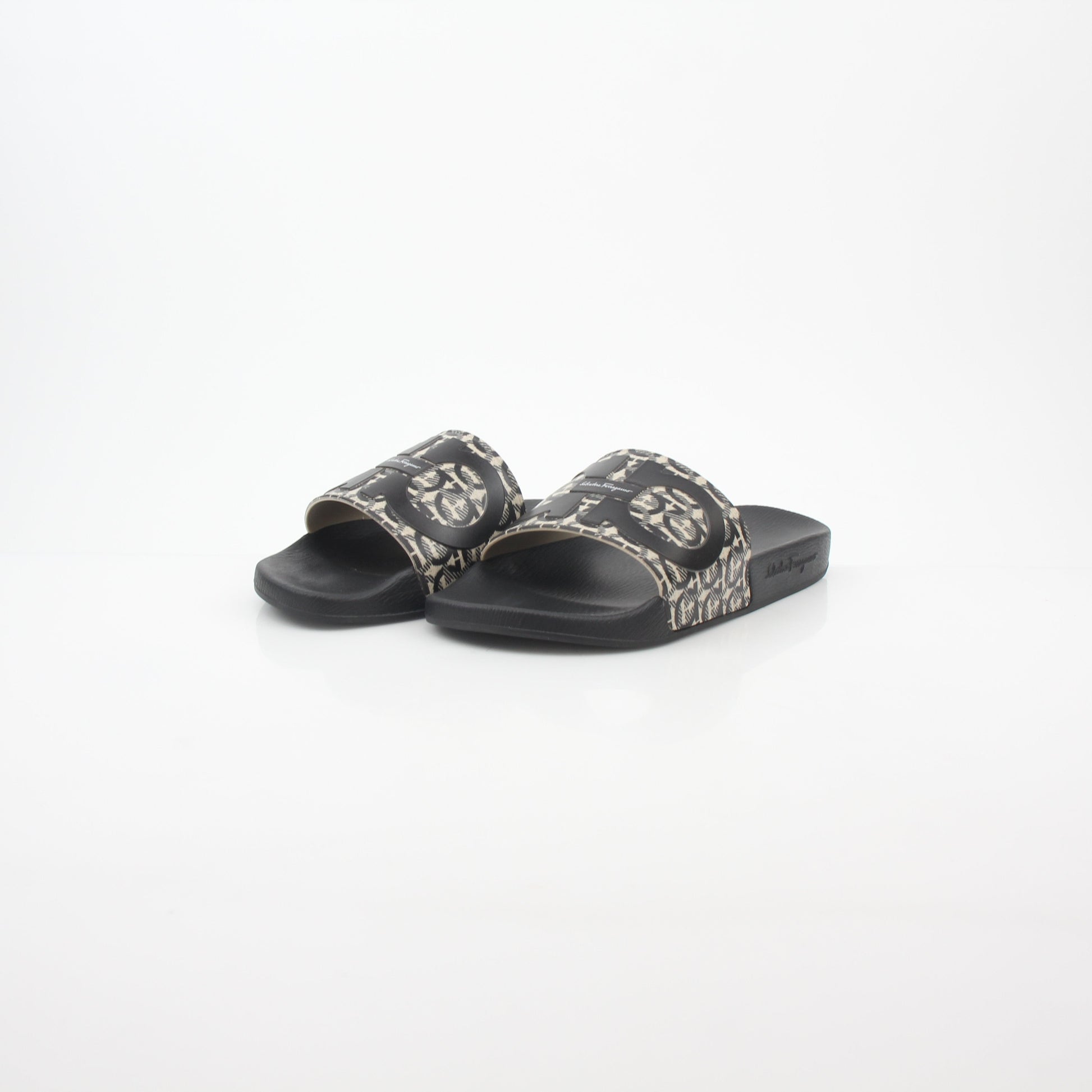 Black and beige Salvatore Ferragamo Groove 6 Gancini slide sandals with open toes and Gancini logo straps by Gold & Beyond