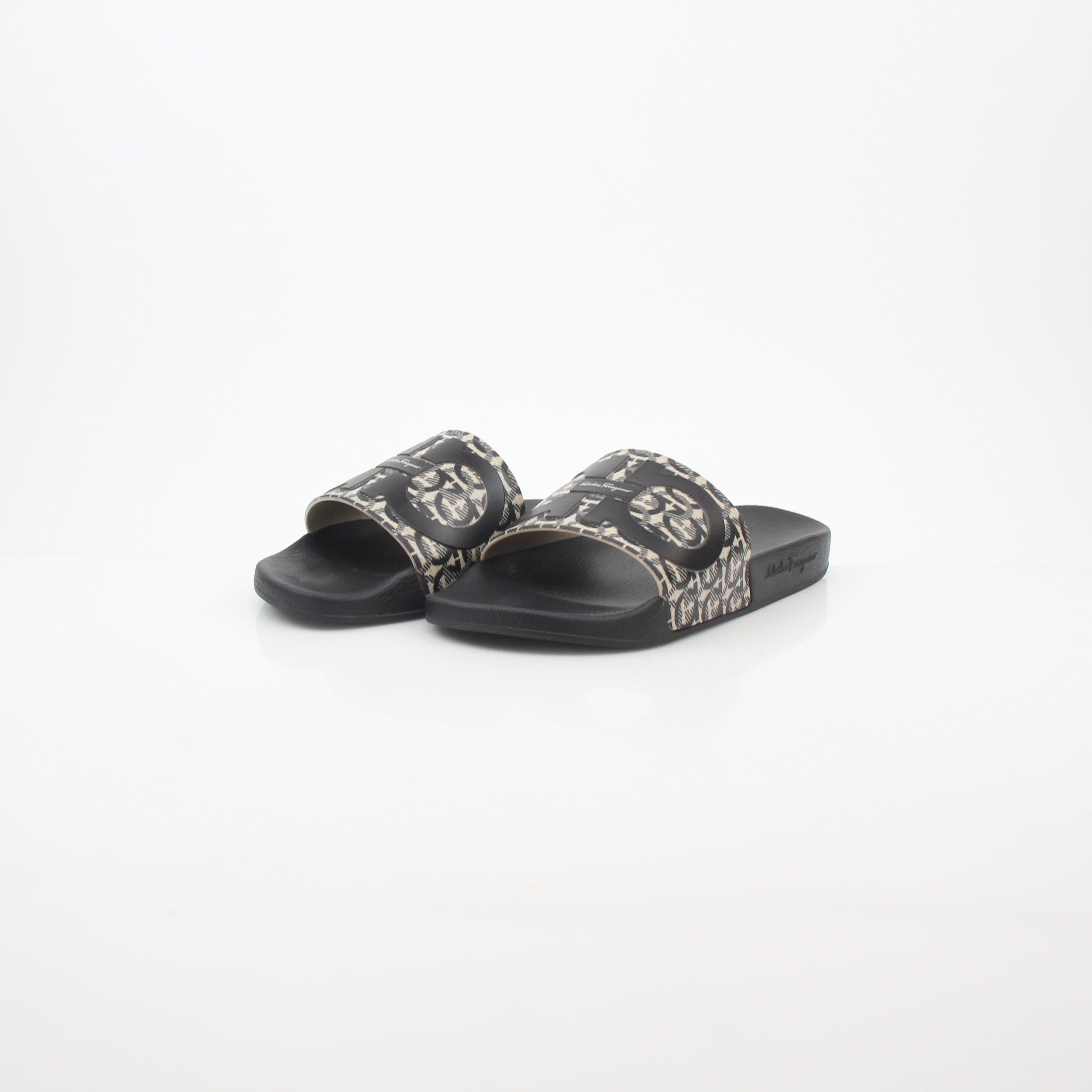 Black and beige Salvatore Ferragamo Groove 6 Gancini slide sandals with open toes and Gancini logo straps by Gold & Beyond