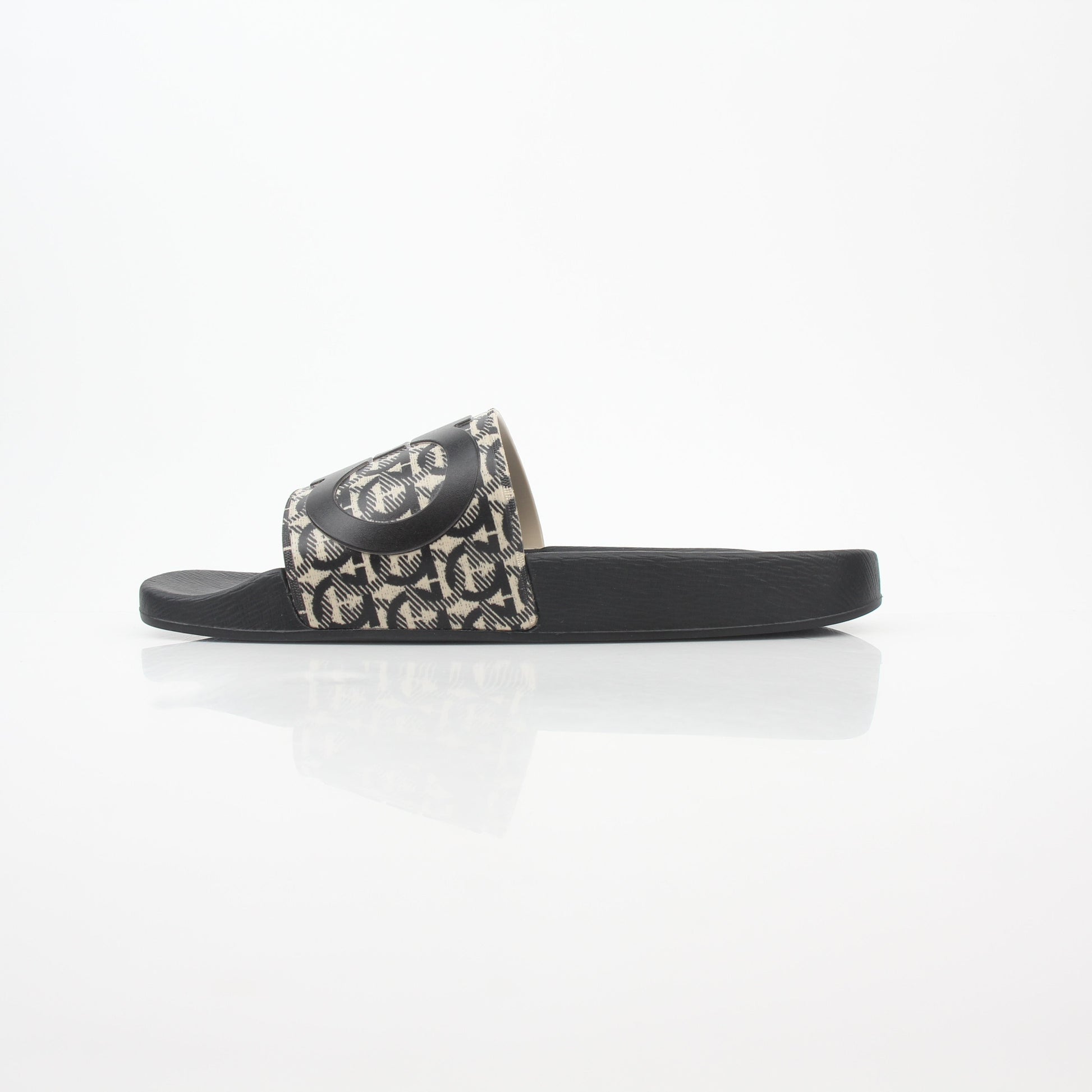 Black and beige Salvatore Ferragamo Groove 6 Gancini slide sandals featuring Gancini logo straps and stylish design.