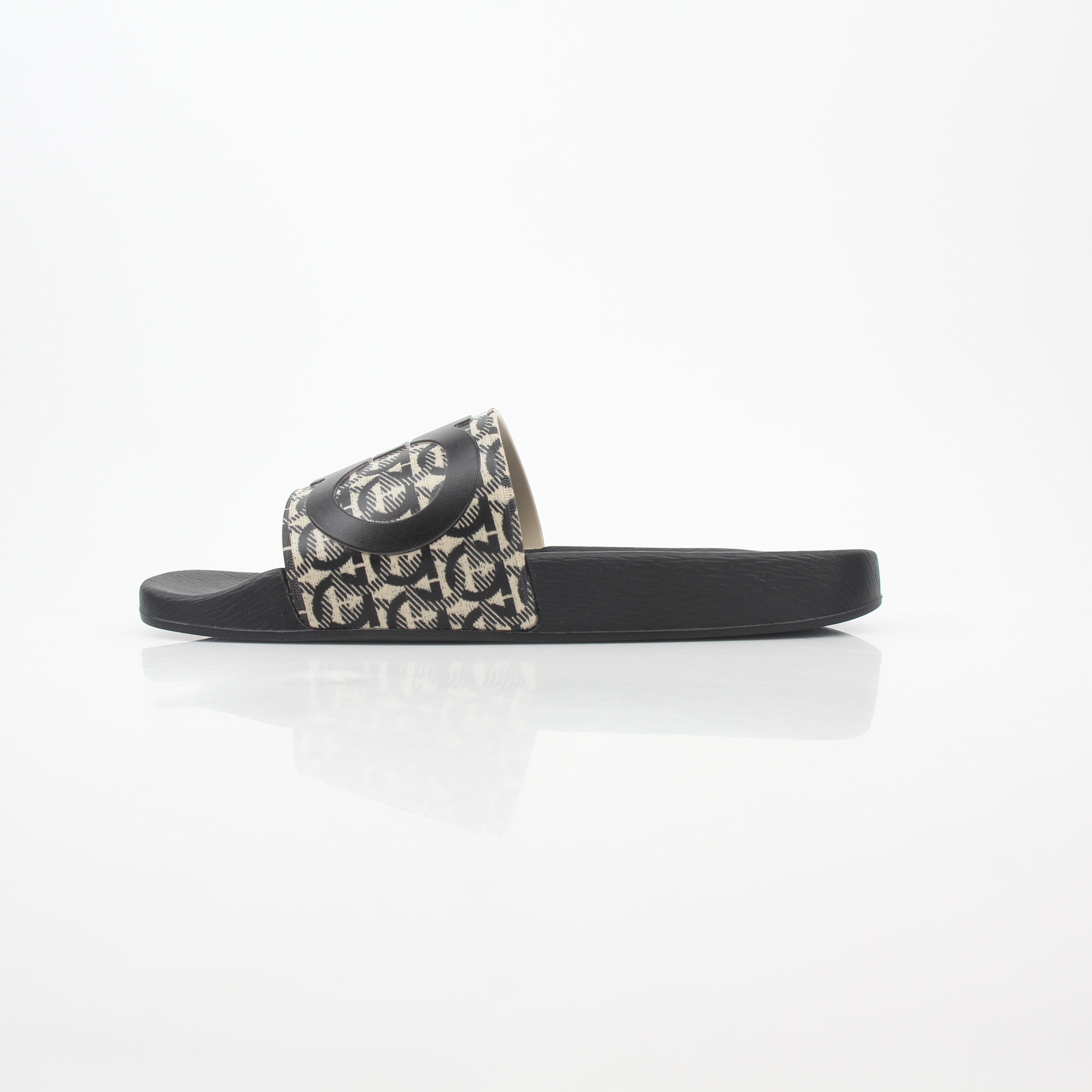 Black and beige Salvatore Ferragamo Groove 6 Gancini slide sandals featuring Gancini logo straps and stylish design.