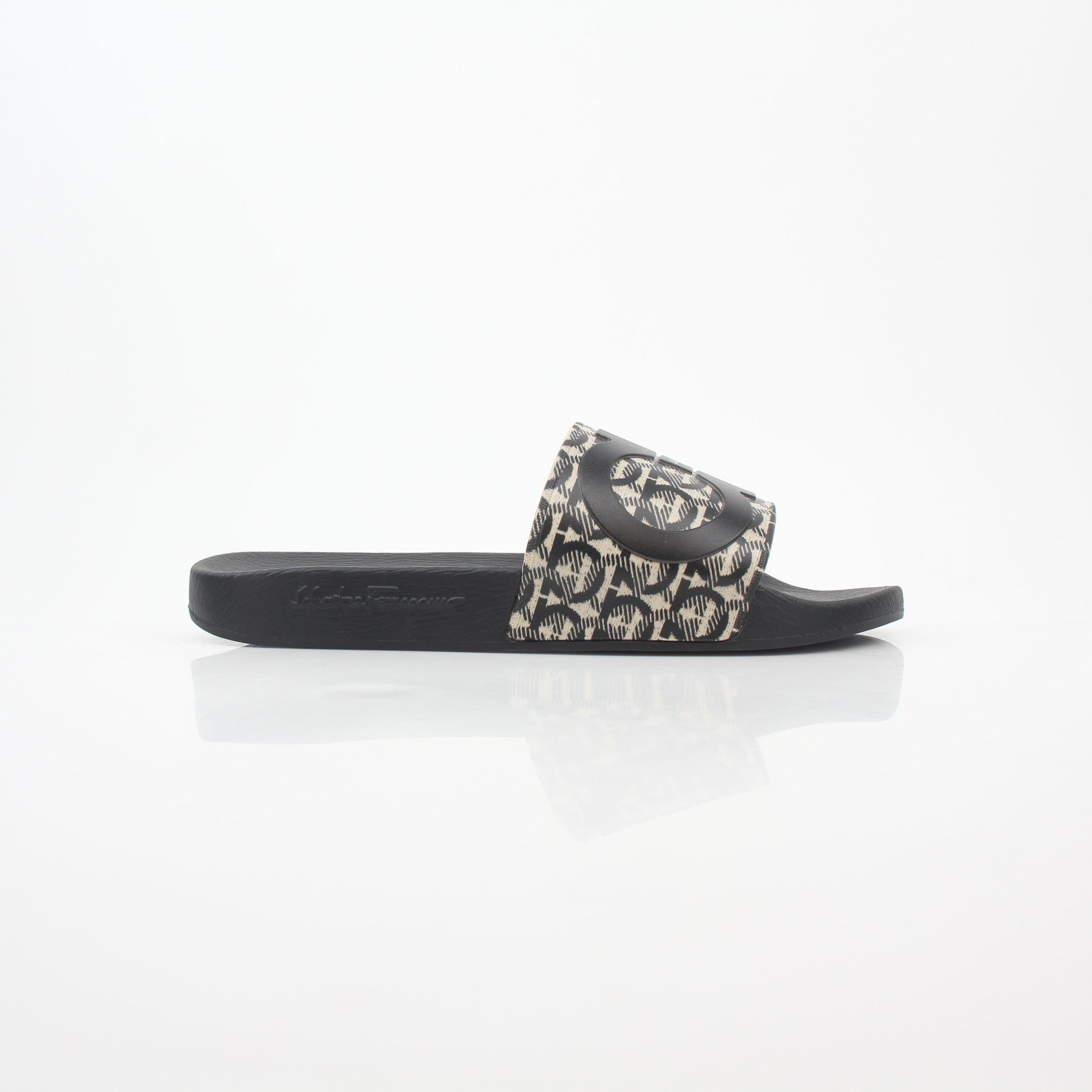 Salvatore Ferragamo black and beige Groove 6 Gancini slide sandals, stylish leather shoes with Gancini hardware detail.