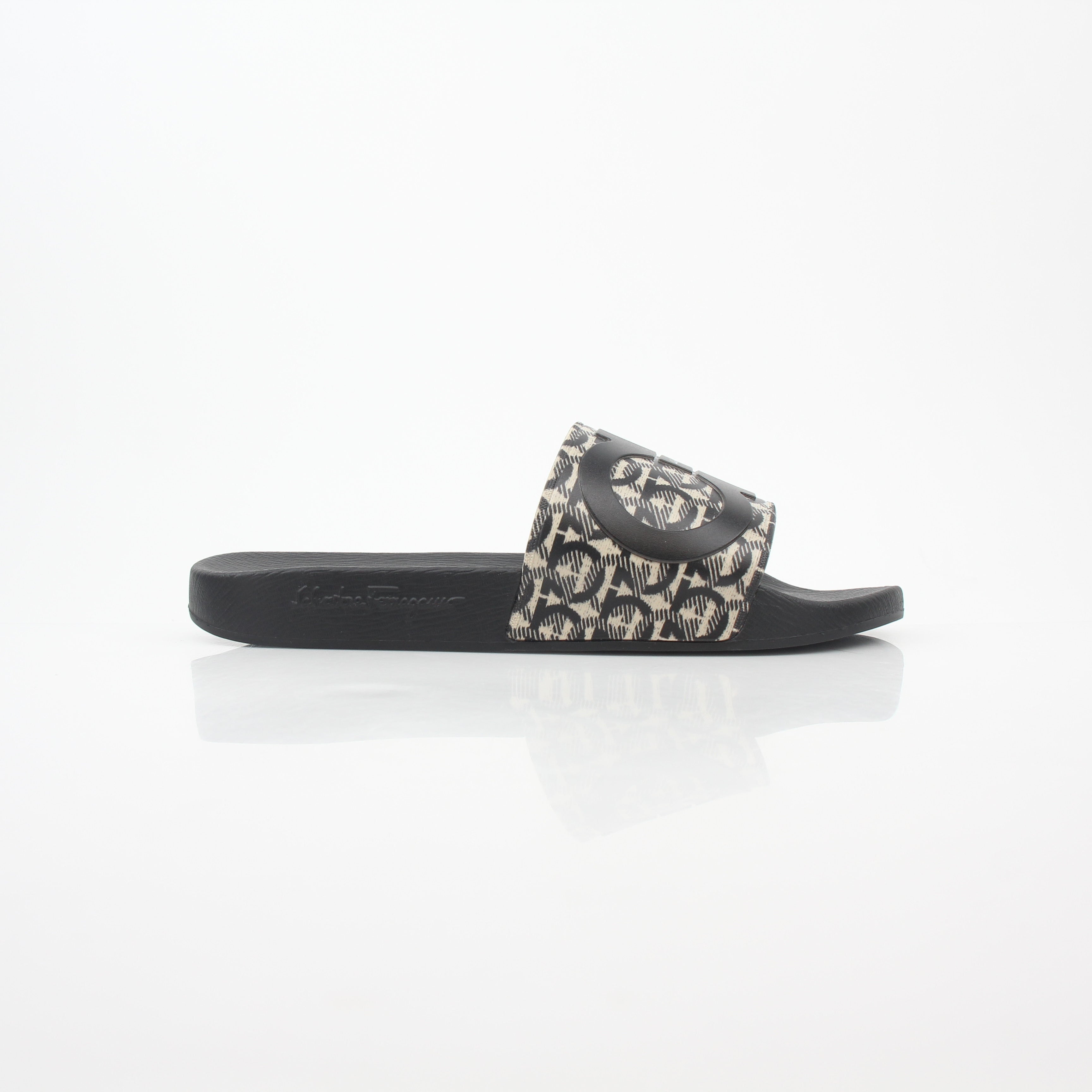 Salvatore Ferragamo black and beige Groove 6 Gancini slide sandals, stylish leather shoes with Gancini hardware detail.