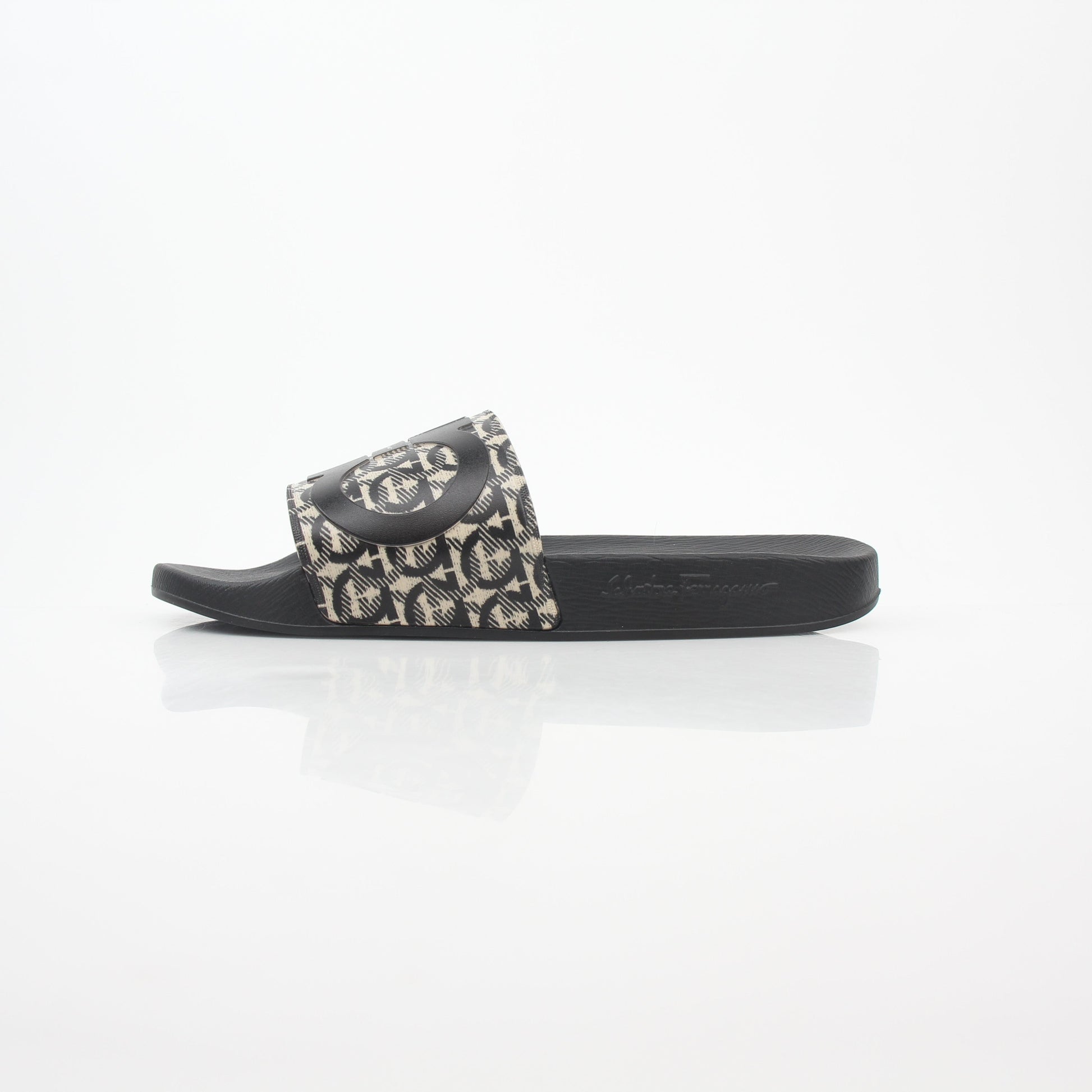 Salvatore Ferragamo black and beige Groove 6 Gancini slide sandals with signature Gancini buckle and comfortable slip-on design.