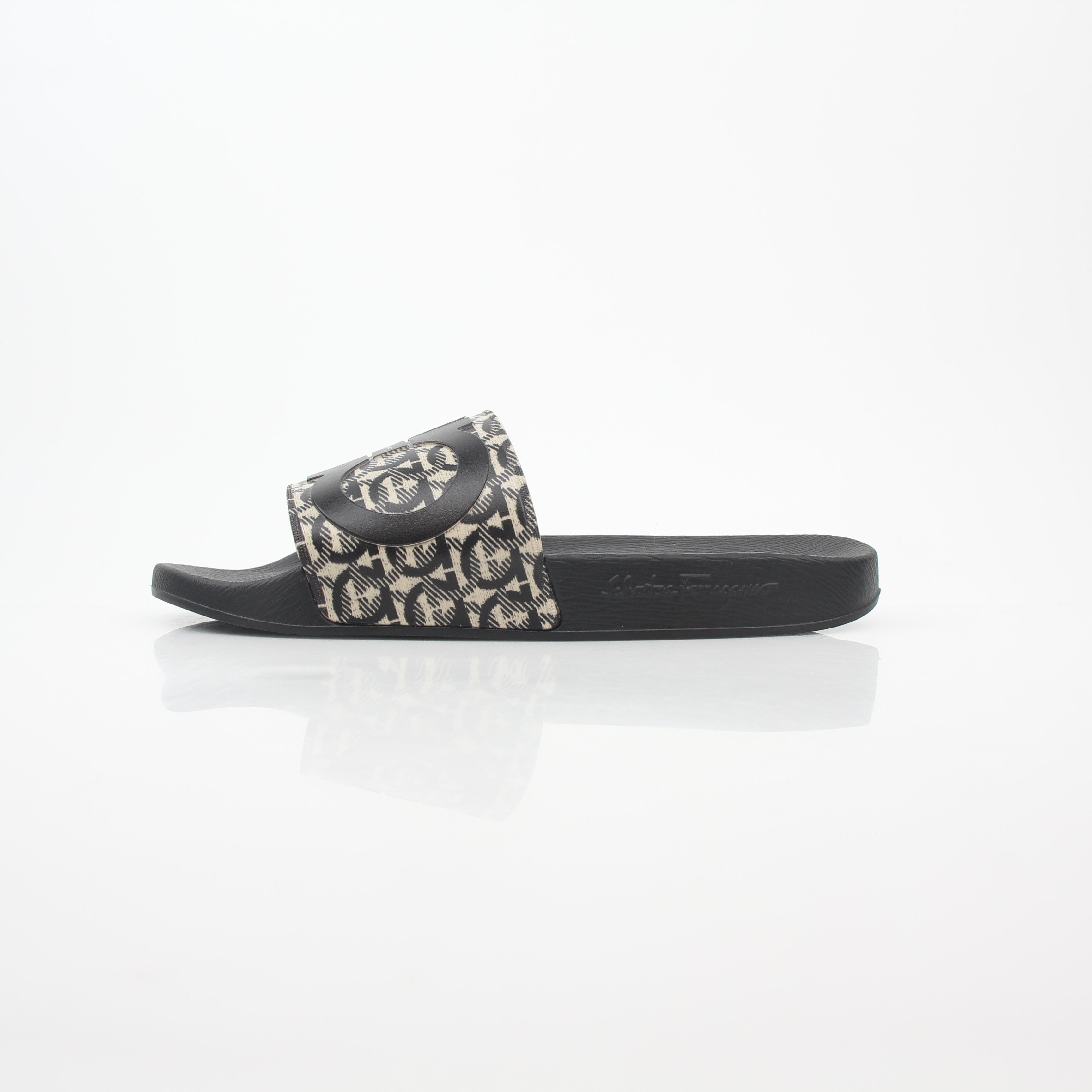 Salvatore Ferragamo black and beige Groove 6 Gancini slide sandals with signature Gancini buckle and comfortable slip-on design.