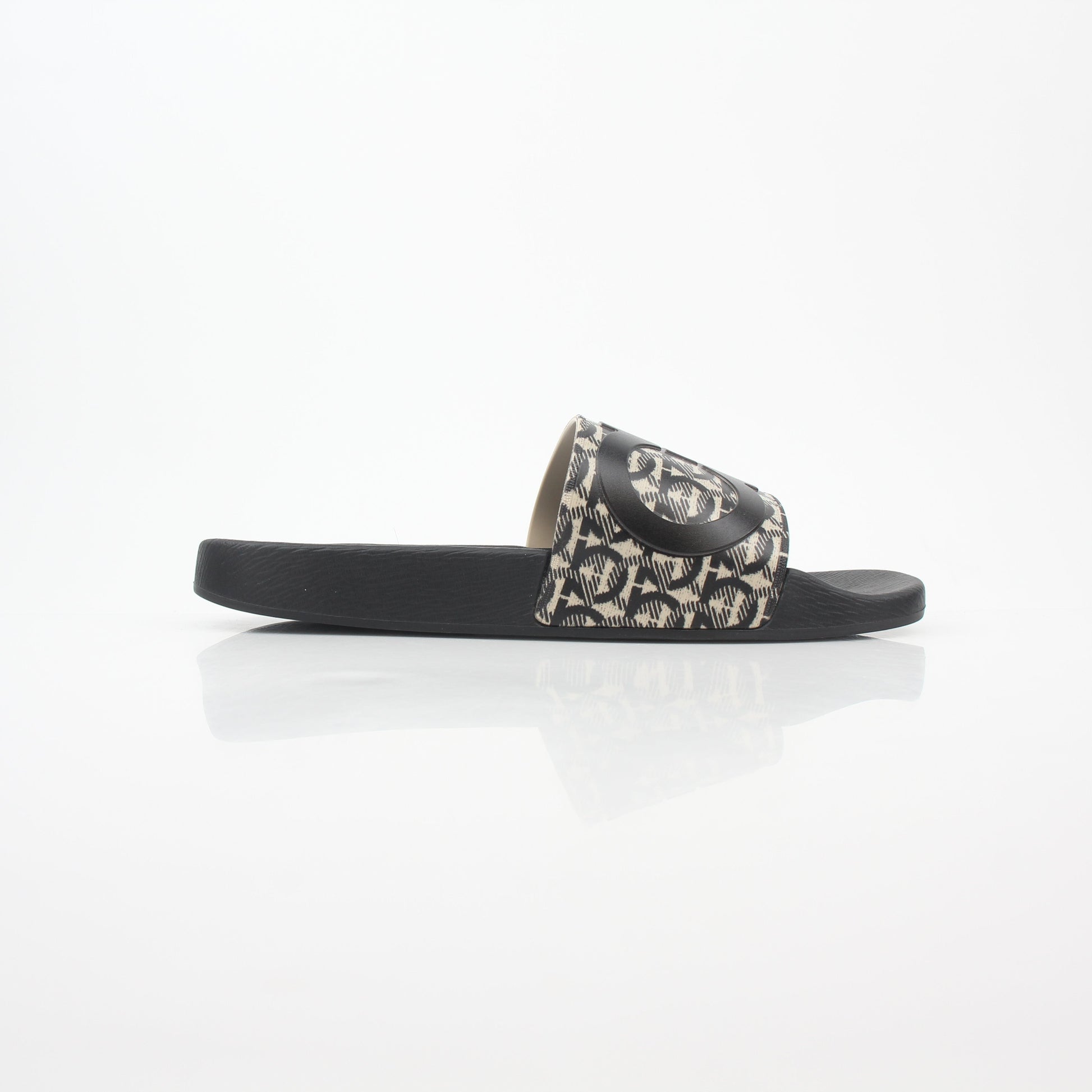 Salvatore Ferragamo black and beige Groove 6 Gancini slide sandals featuring leather straps and signature Gancini hardware.