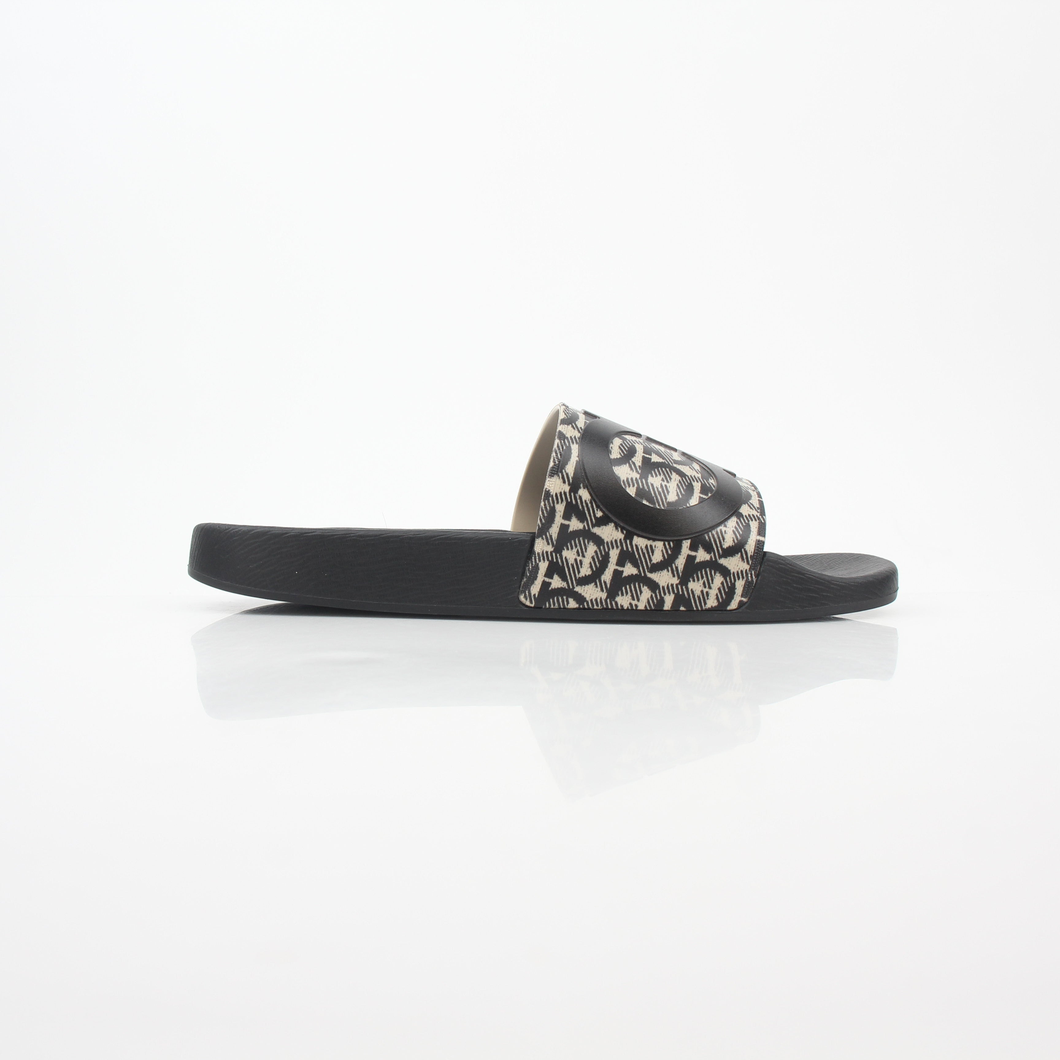 Salvatore Ferragamo black and beige Groove 6 Gancini slide sandals featuring leather straps and signature Gancini hardware.