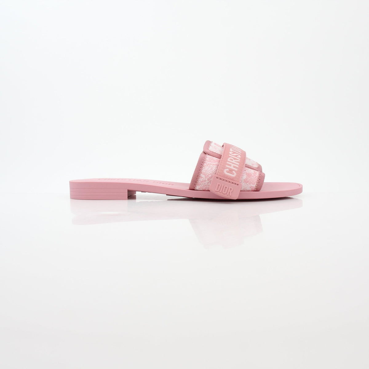 Pink Christian Dior Dioriviera Dio(r)evolution slides, stylish shoes with Dior branding and vibrant design, on a neutral background.