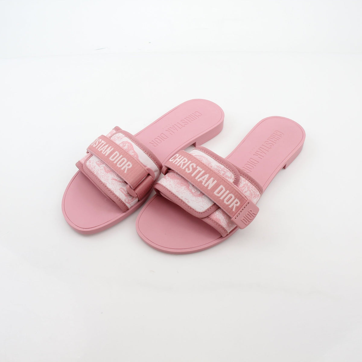 Pink Dioriviera Dior(r)evolution Slides shoes by Christian Dior, featuring a stylish pink design with Dior branding and slide style.