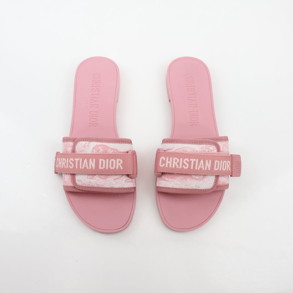 Pink Dioriviera Dio(r)evolution slides by Christian Dior, featuring a stylish slip-on shoe with Dior branding and vibrant pink color.