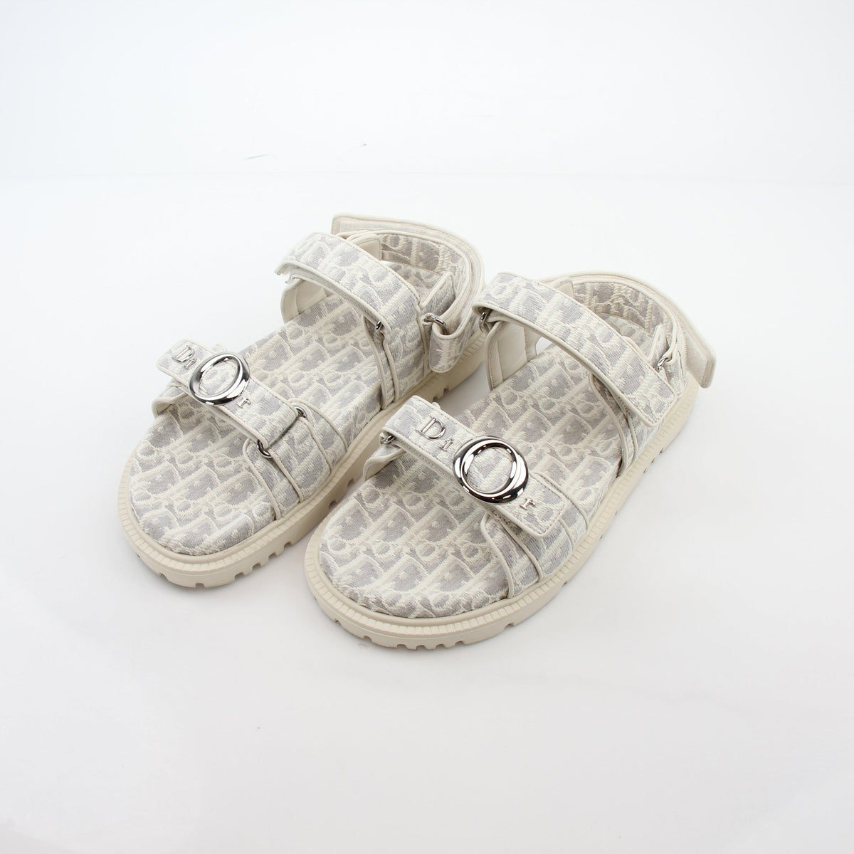 Christian Dior White and Gray Dioract Oblique Sandals with sleek straps and stylish design, displayed on a plain background.