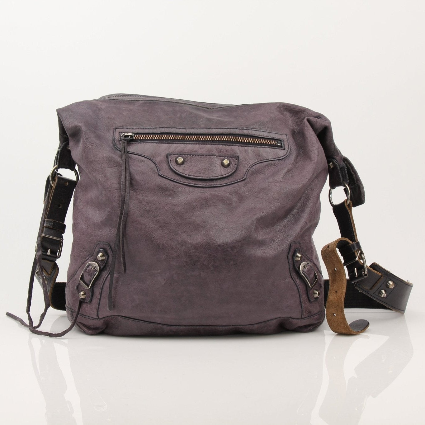 Balenciaga purple distressed leather messenger bag with adjustable shoulder strap and spacious interior.