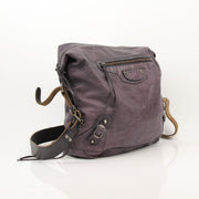 Balenciaga purple distressed leather messenger handbag with adjustable strap and metal hardware, stylish and casual accessory.