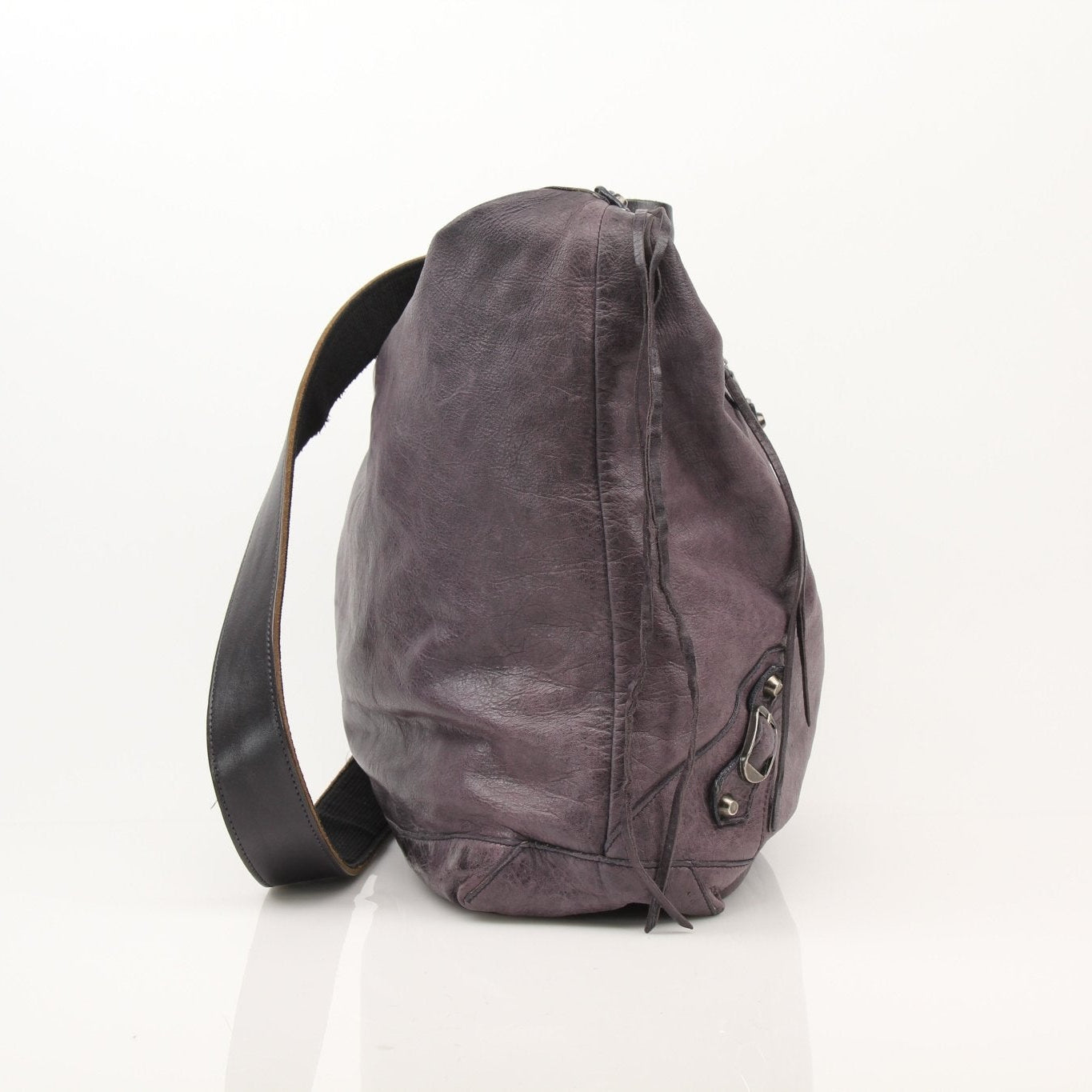 Purple distressed Balenciaga messenger handbag with adjustable strap and signature design, featuring a spacious interior and urban style.