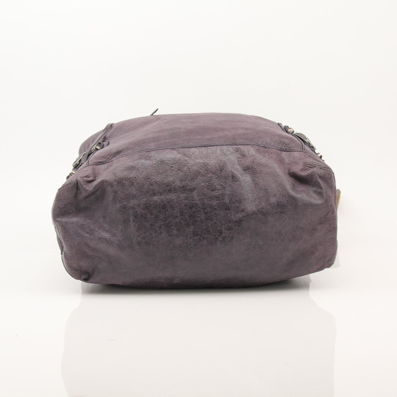 Purple Balenciaga distressed leather messenger handbag with adjustable strap and modern design.